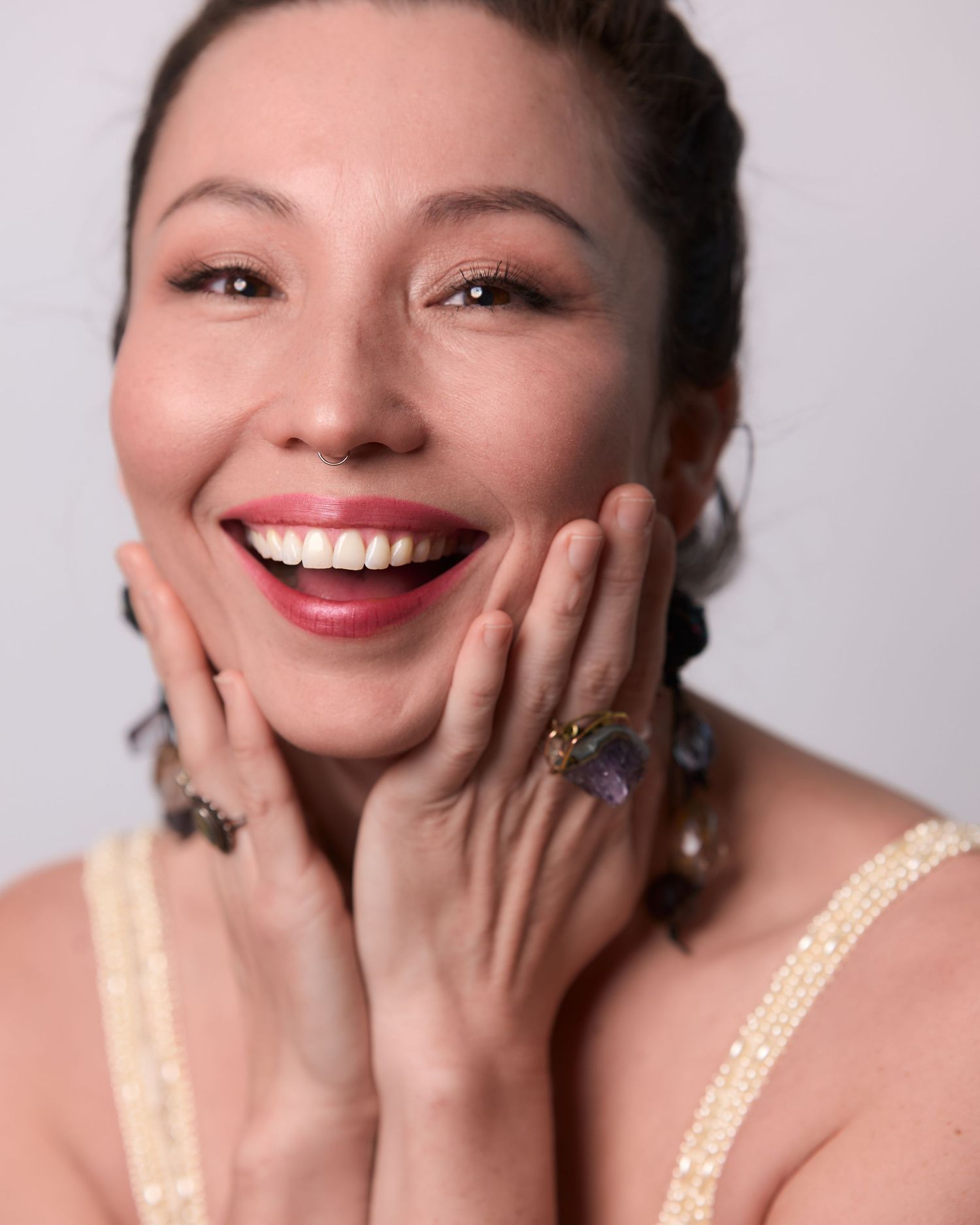 Candid portrait series showing genuine laughter and happiness against white backdrop.