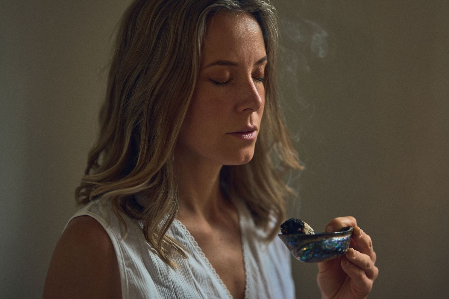 Atmospheric portrait showing smoke and contemplative moments in dim lighting.