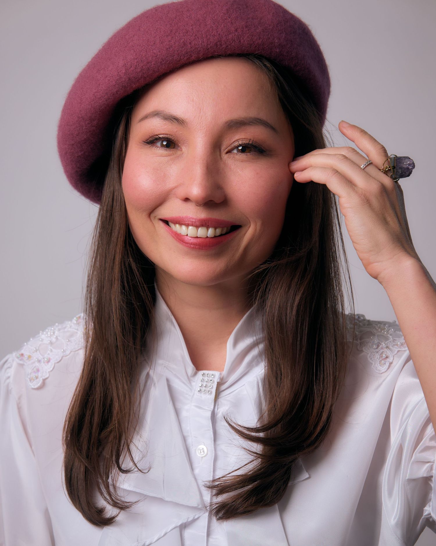 Fashion portrait series with burgundy beret, white blouse, and playful expressions.