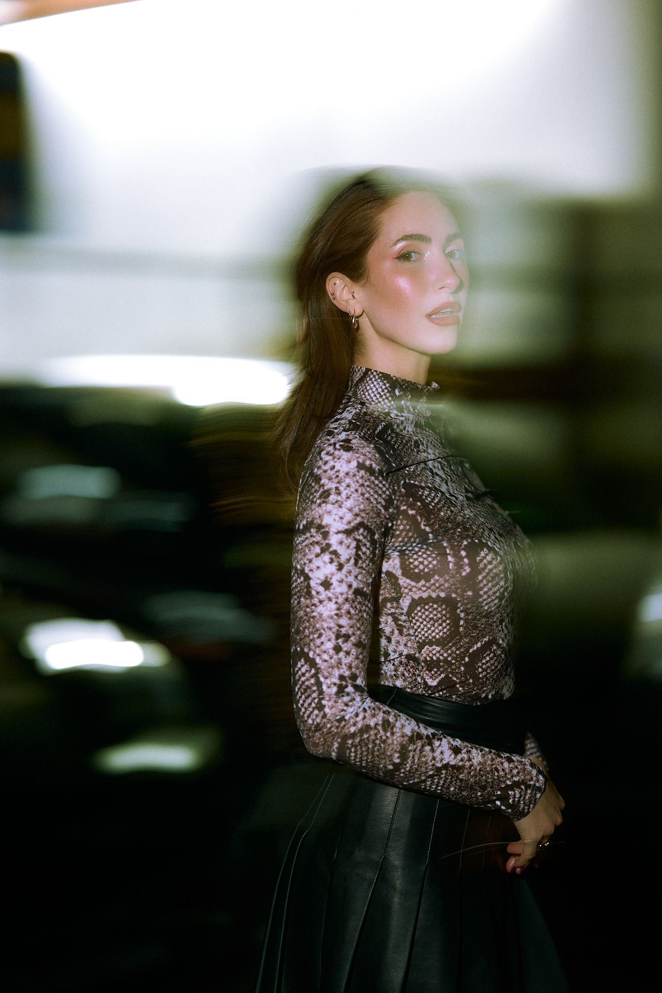 Fashion portrait featuring a sequined turtleneck top in dramatic lighting.