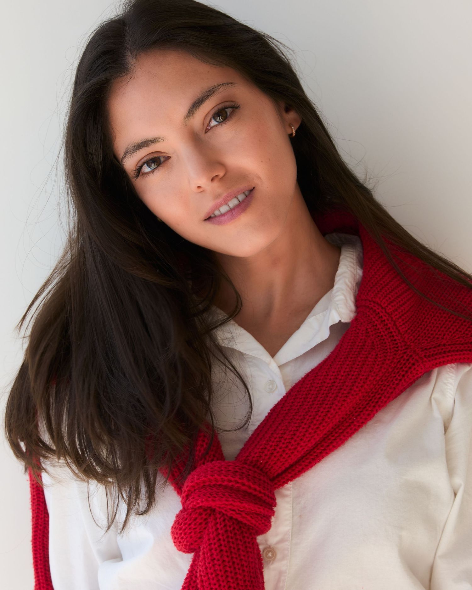 Fashion portraits with red scarf and white shirt combination in natural lighting.
