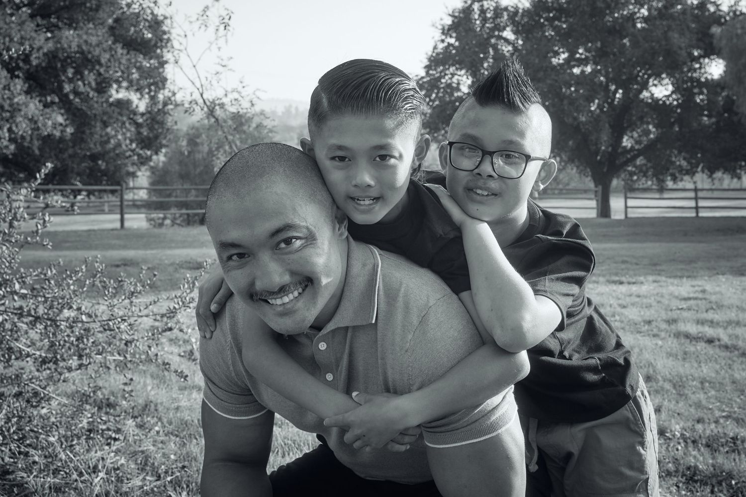Candid black and white family moments captured outdoors.