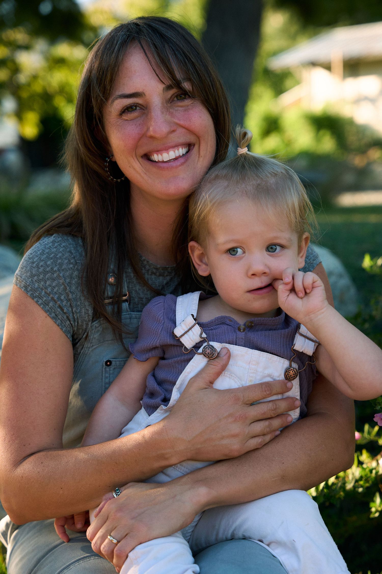 Outdoor portrait session in sunny garden setting.