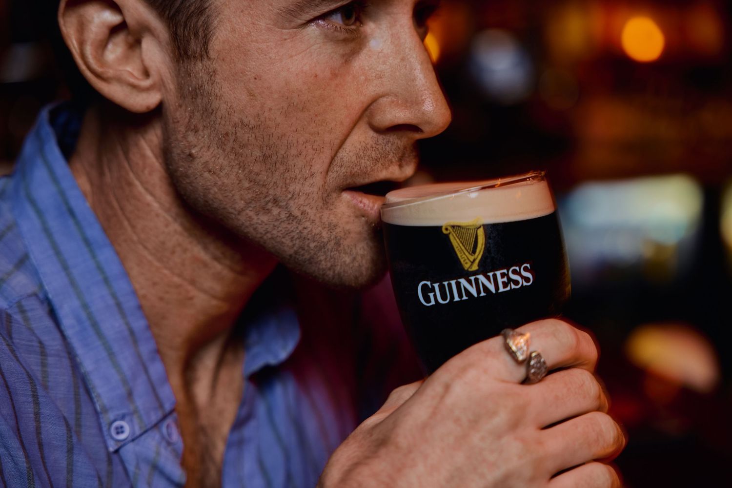 Multiple close-up shots of someone enjoying a pint of Guinness beer in a dim bar setting.