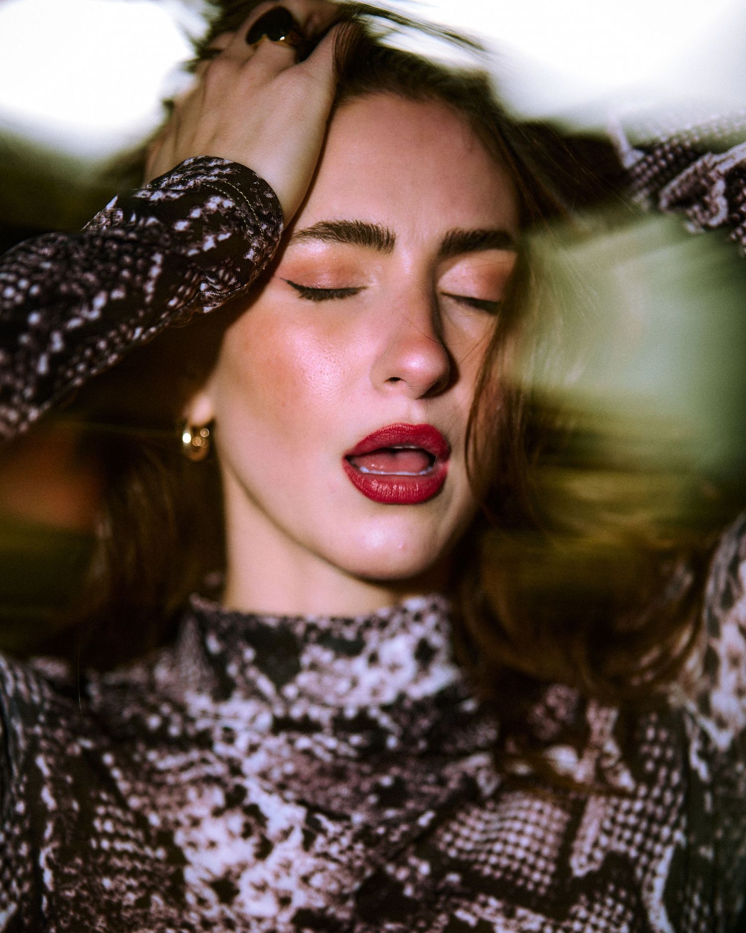 Artistic beauty shot with sequined outfit and bold red lips.