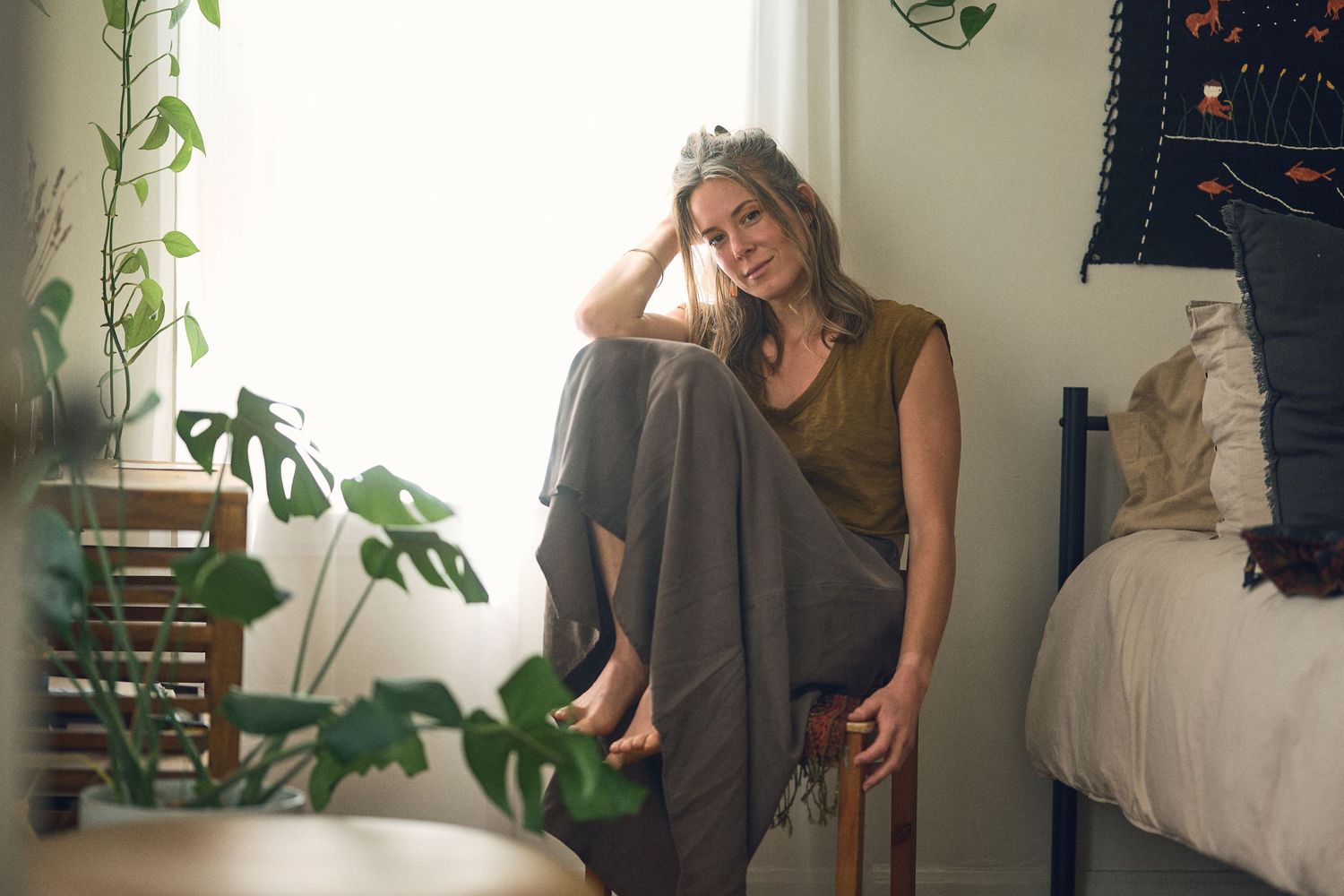 A series of candid lifestyle photos showing someone in casual clothing against a light interior background.