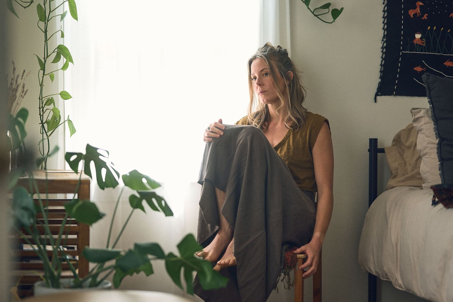 Interior scene with houseplants and natural light streaming through windows.