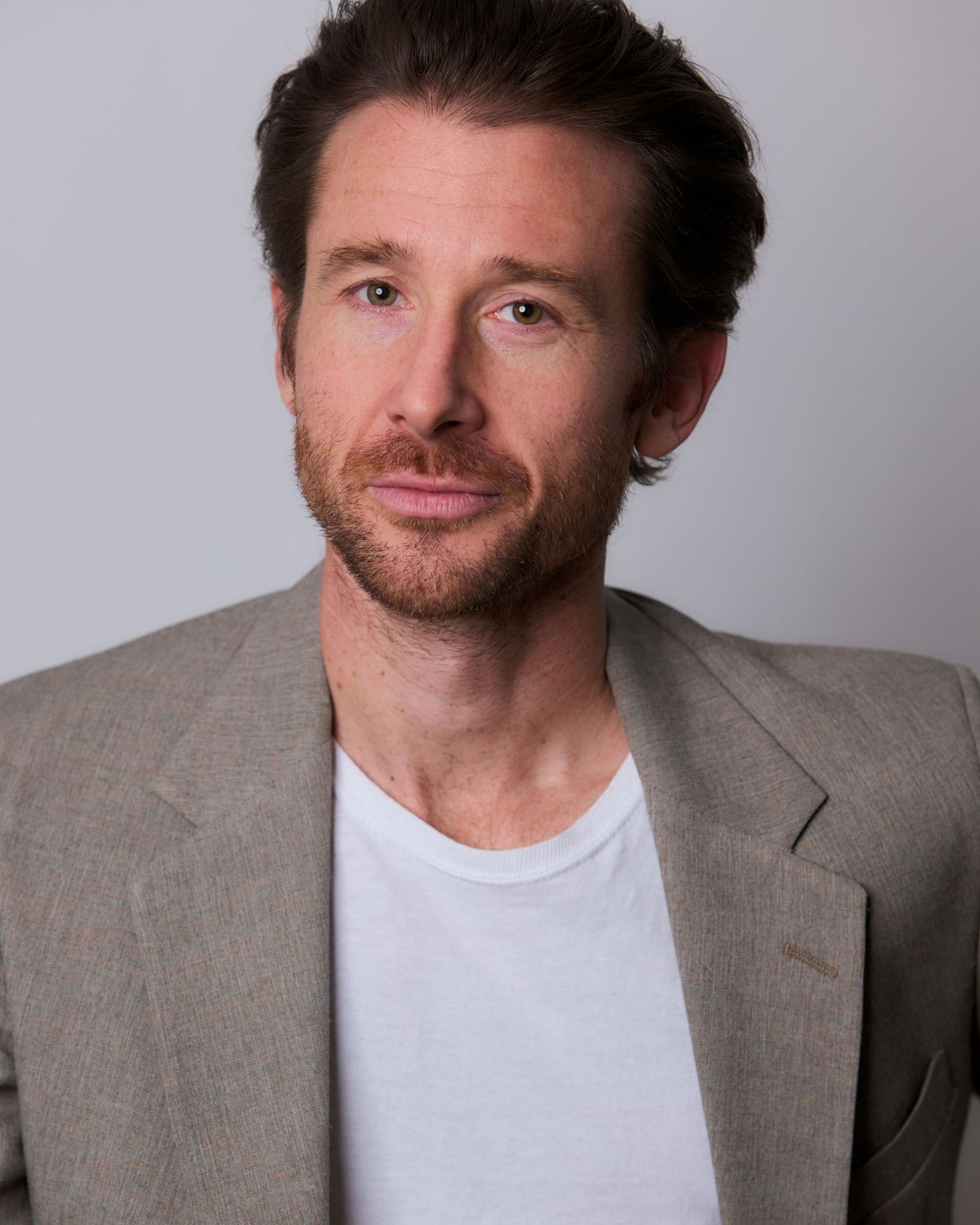 Professional headshots featuring grey suit jacket and white t-shirt combination.