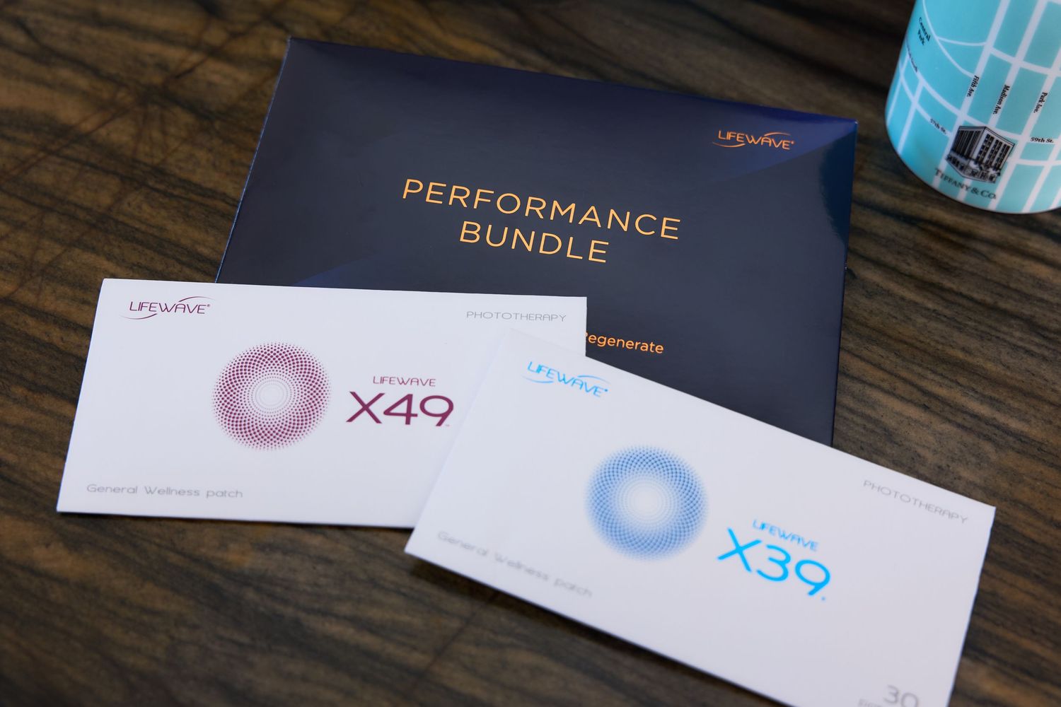 Multiple product boxes and packaging materials from Ubiquiti networking equipment laid out on a wooden surface.
