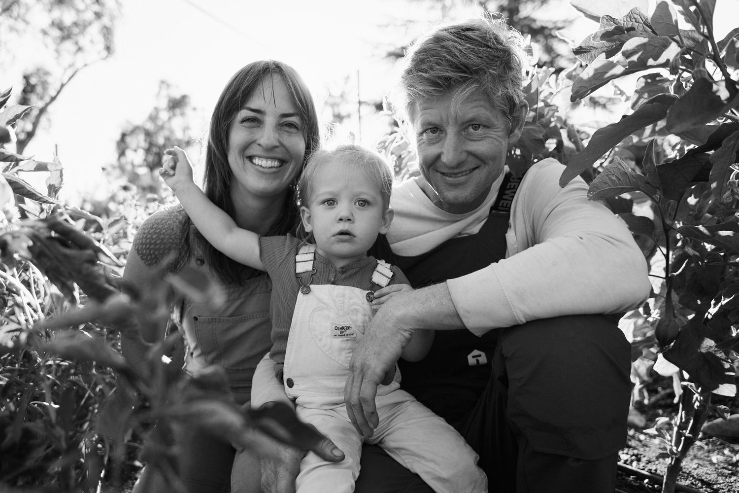 Black and white family photos showing joyful outdoor moments together.