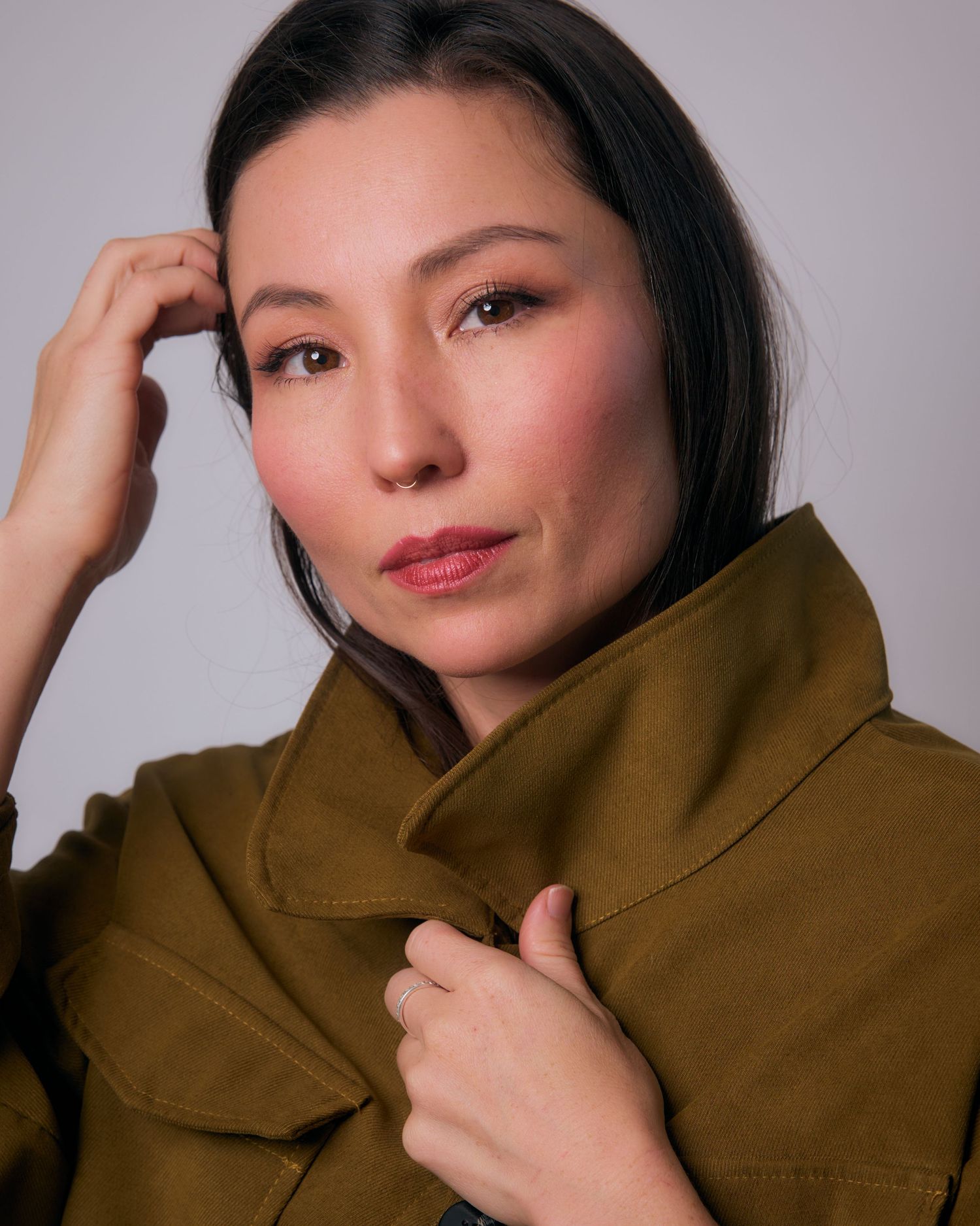 Artistic portrait series featuring olive turtleneck sweater and subtle expressions.