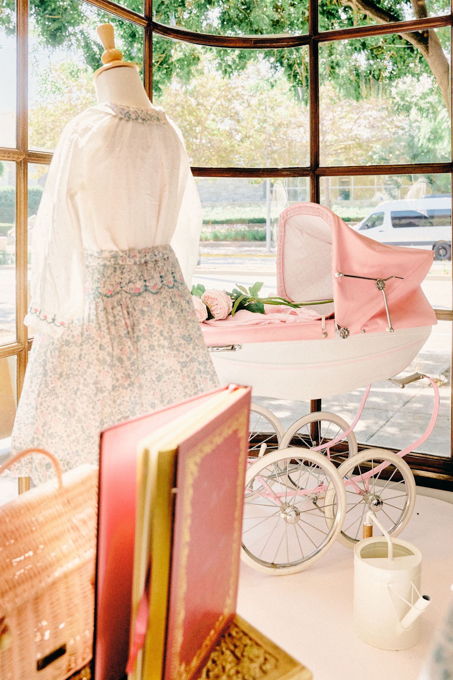 Vintage pink and white bicycles displayed in a sunlit room with floral decor and soft lighting.