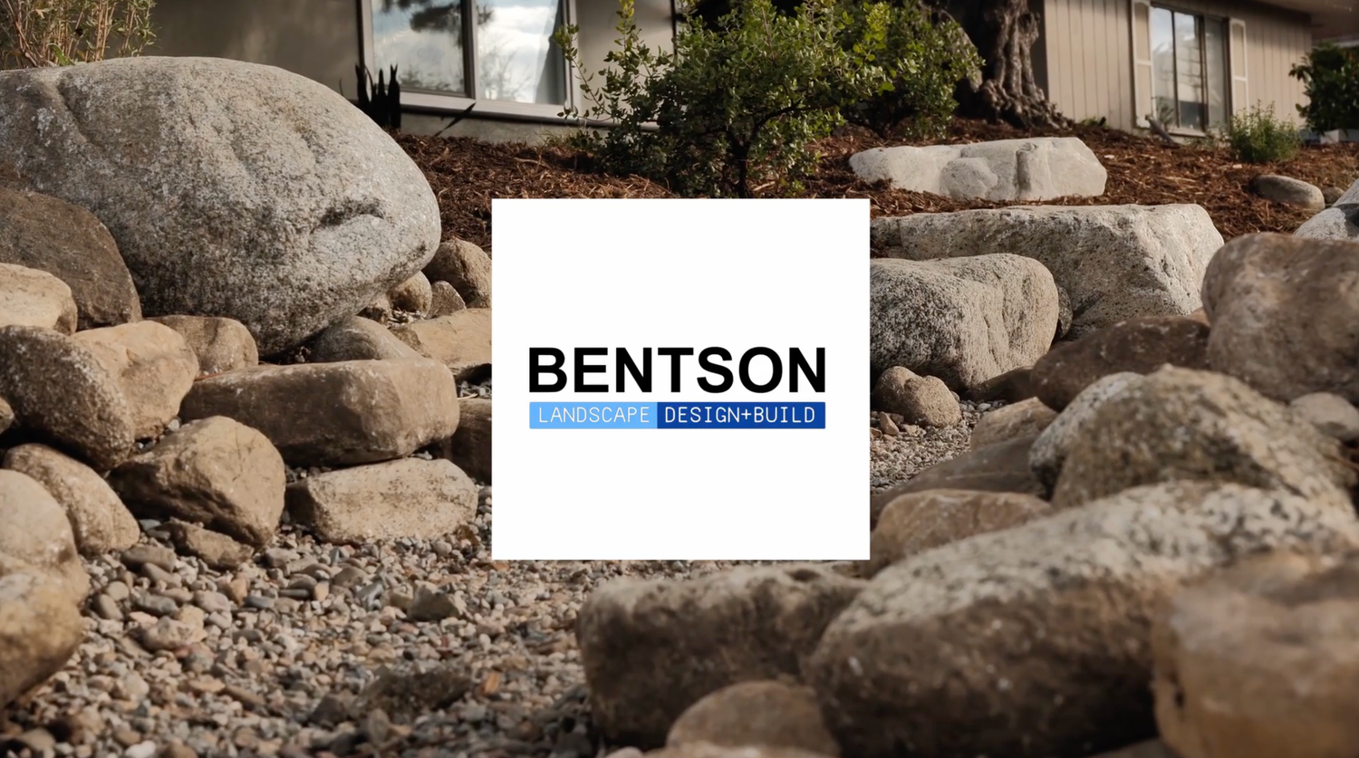 Natural stone landscaping with large boulders and rocks creates a rustic outdoor design element.