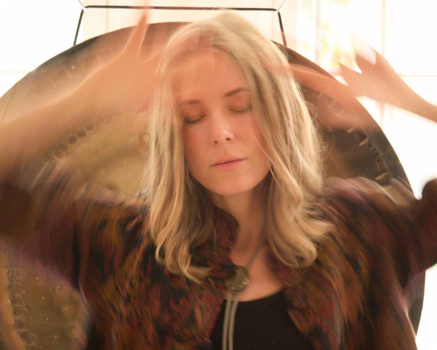 Series of soft-lit portraits with flowing blonde hair in motion.