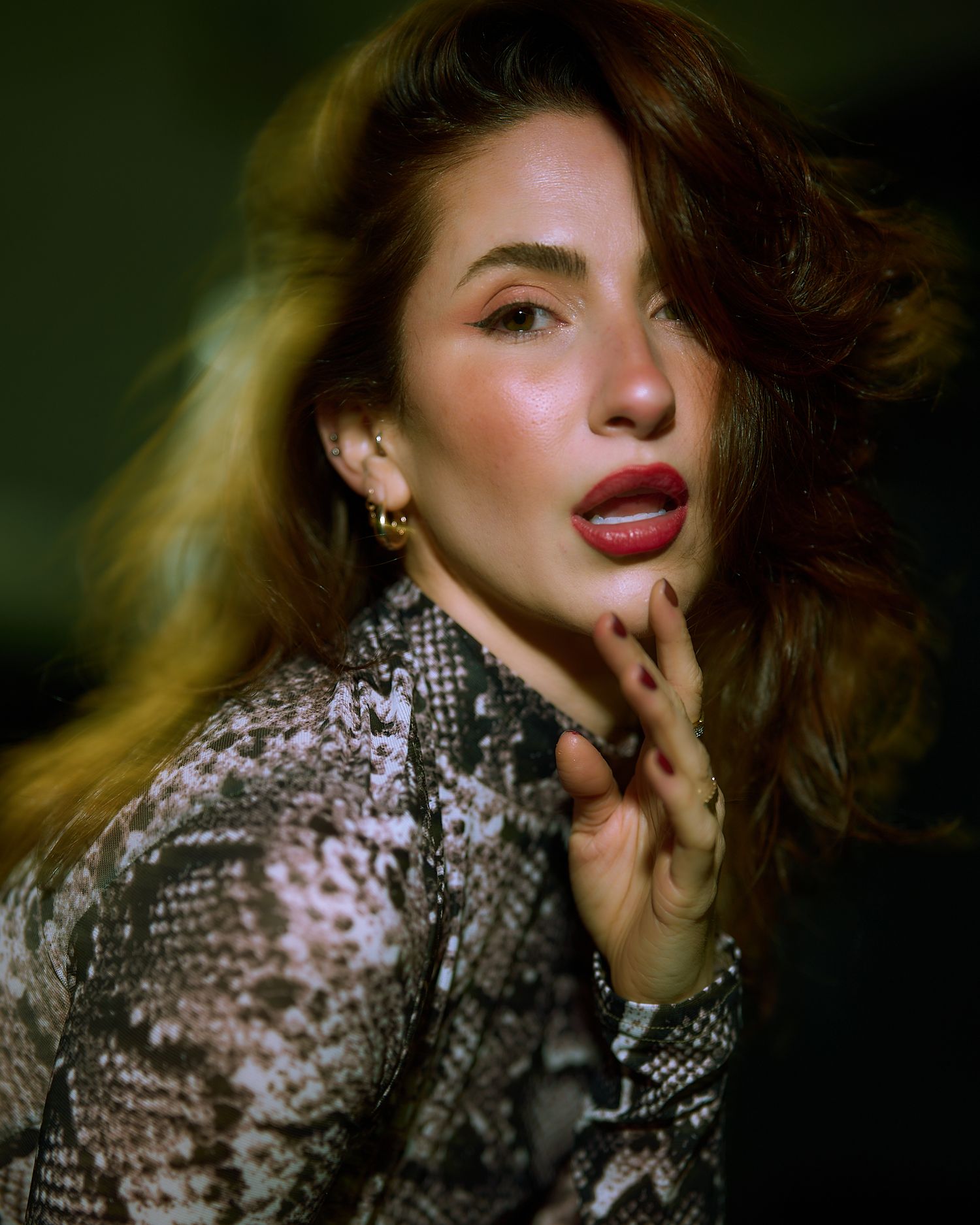 Glamorous portrait in sparkling sequined outfit with dramatic lighting and movement.