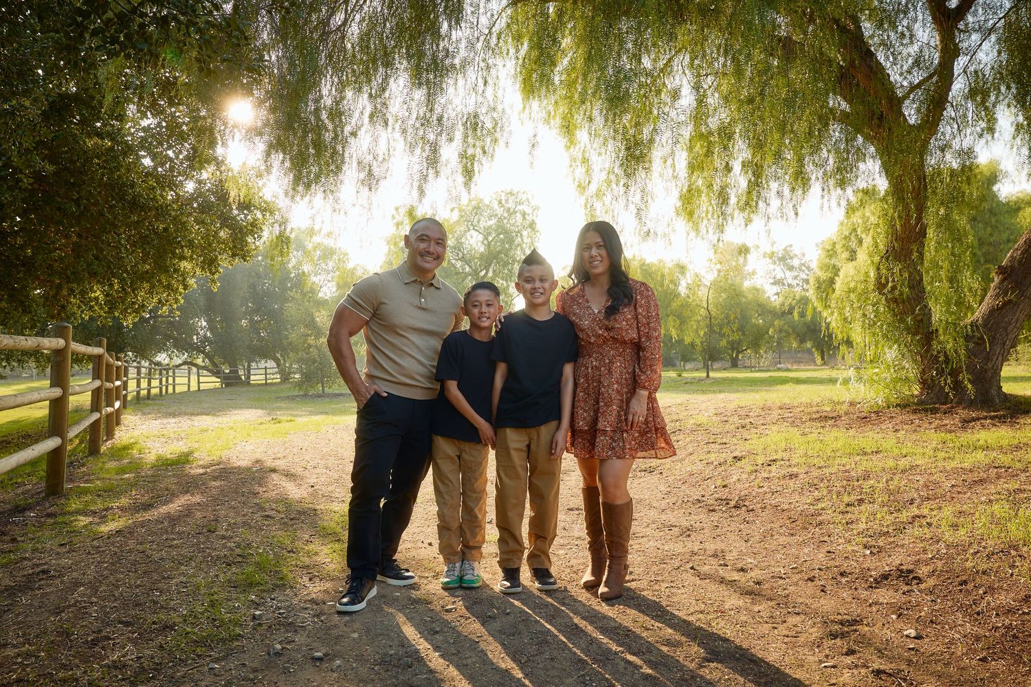 Family portrait session under willow tree with golden sunset lighting.