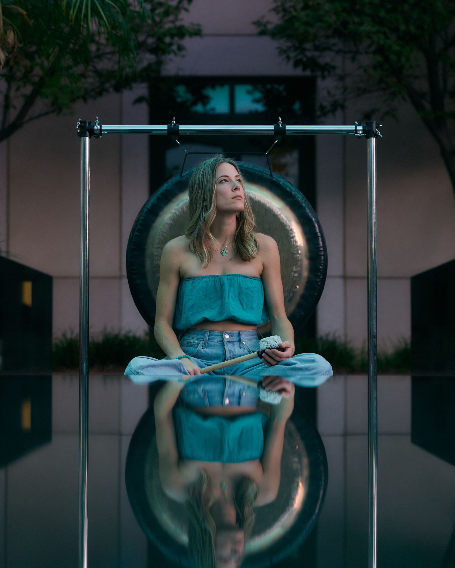 Person relaxing in a modern lounge chair under blue lighting.