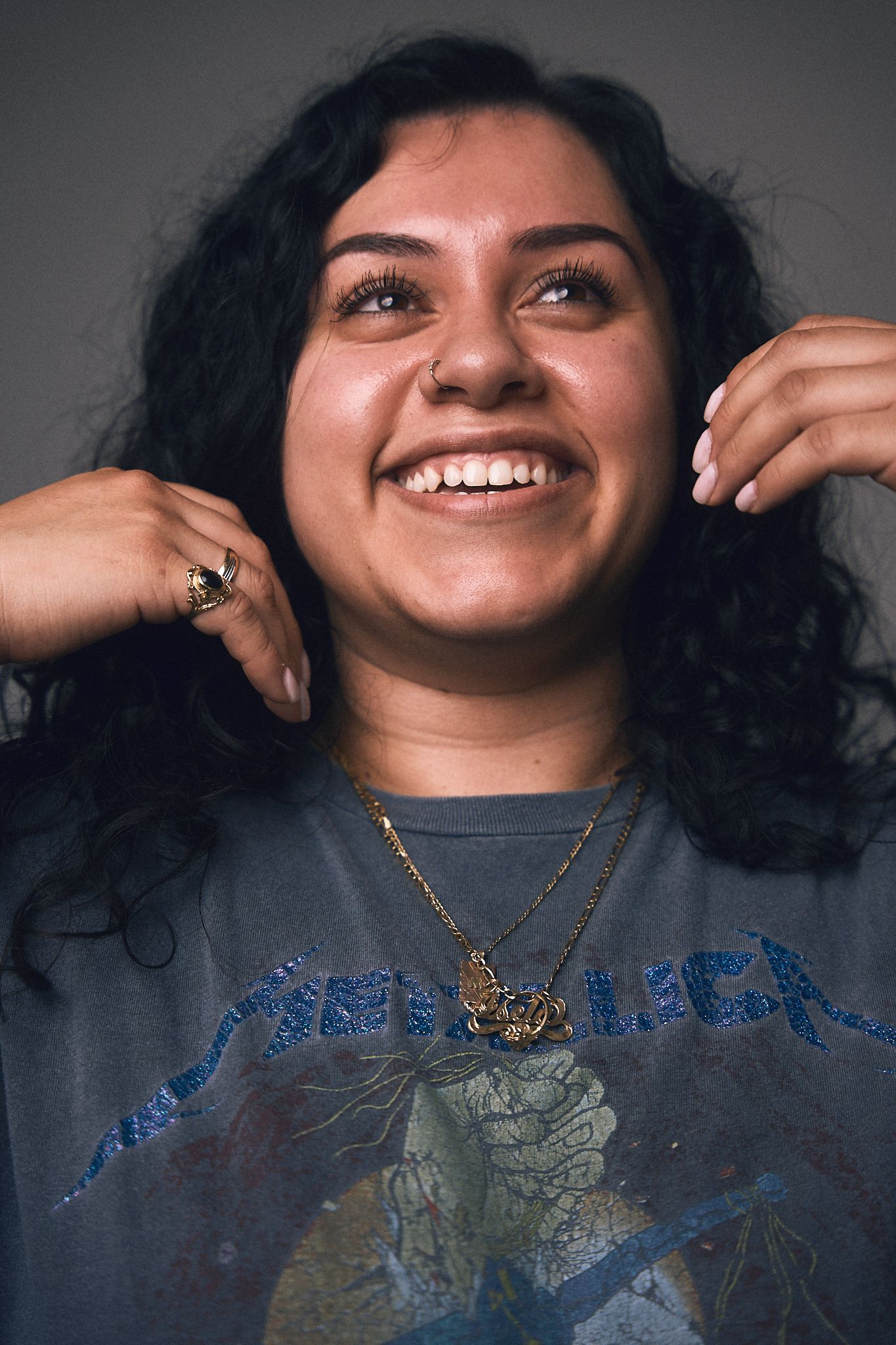 Portrait sequence showing joyful expressions and animated gestures with curly hair and necklace.