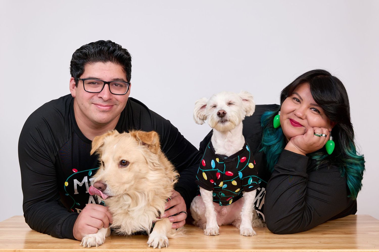 Family portrait session with dogs wearing festive holiday accessories.