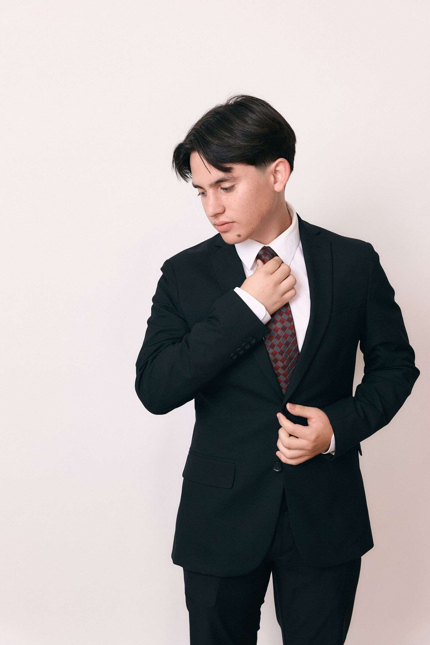 Man in dark suit demonstrating thoughtful poses in professional photo series.