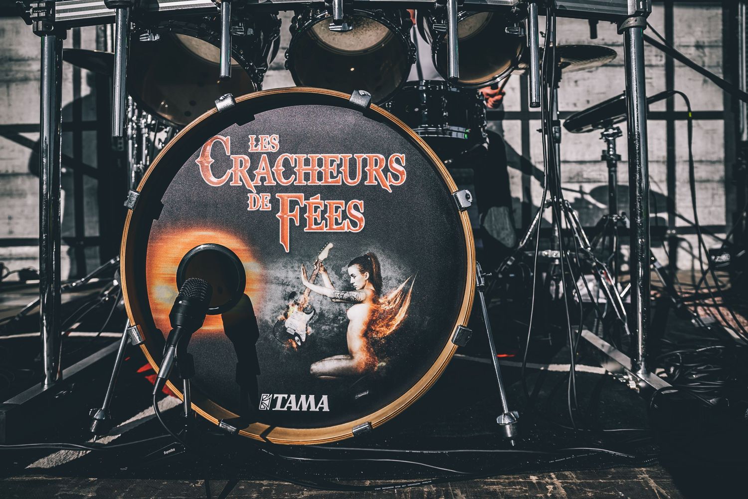 Tama bass drum with Crackwhores and Fires logo on stage setup.