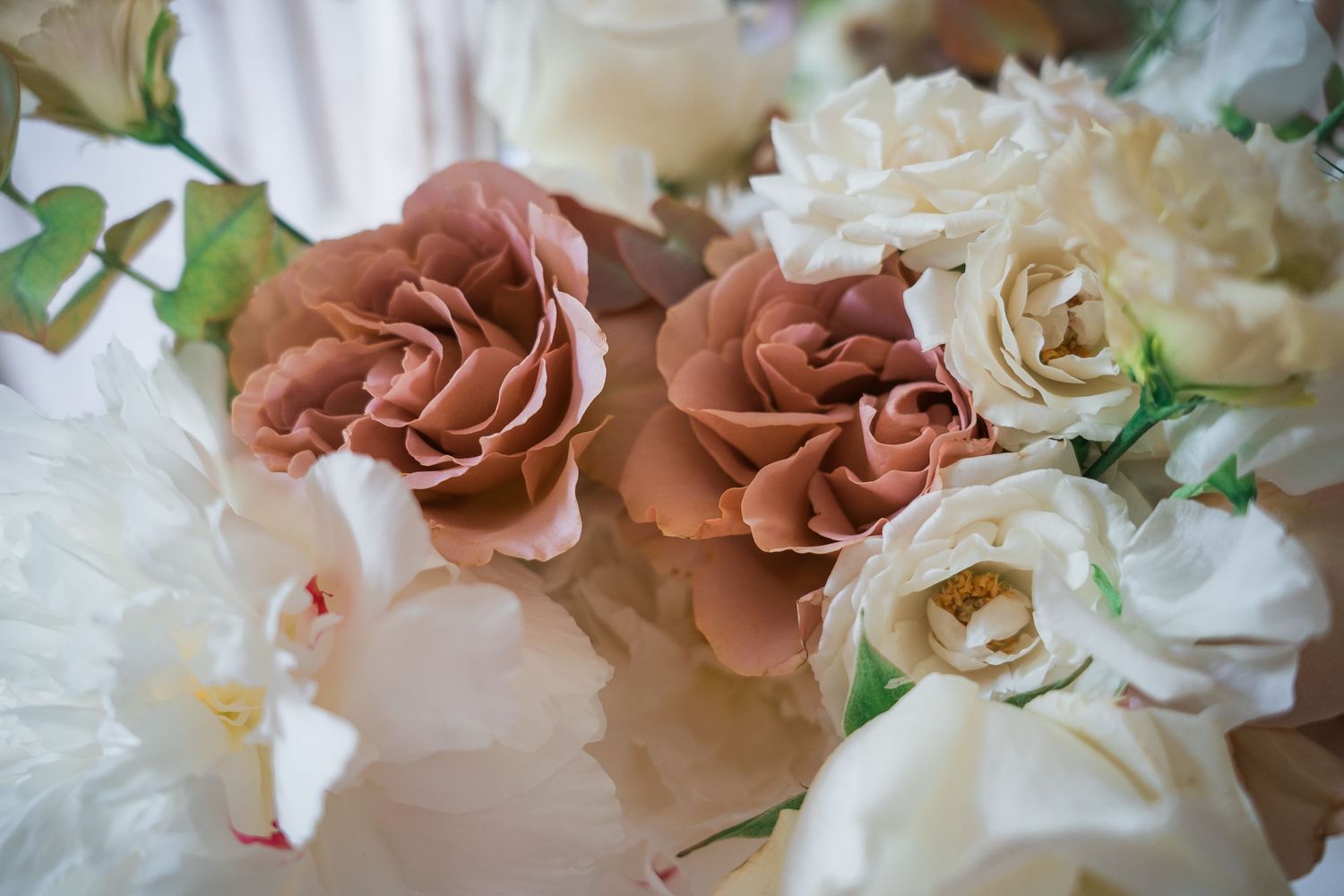Romantic bouquet featuring dusty rose and white roses with delicate floral arrangement.