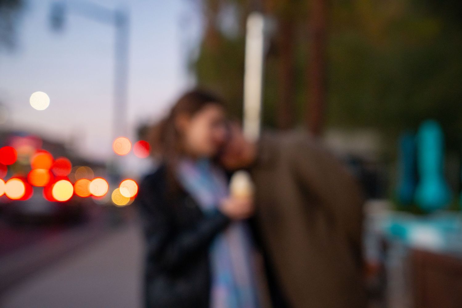 Blurred nighttime street scene with bokeh lights in the background.
