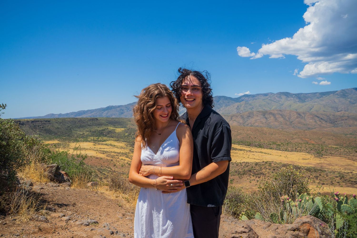 A romantic moment captured in a series of photos with desert mountains in the background.