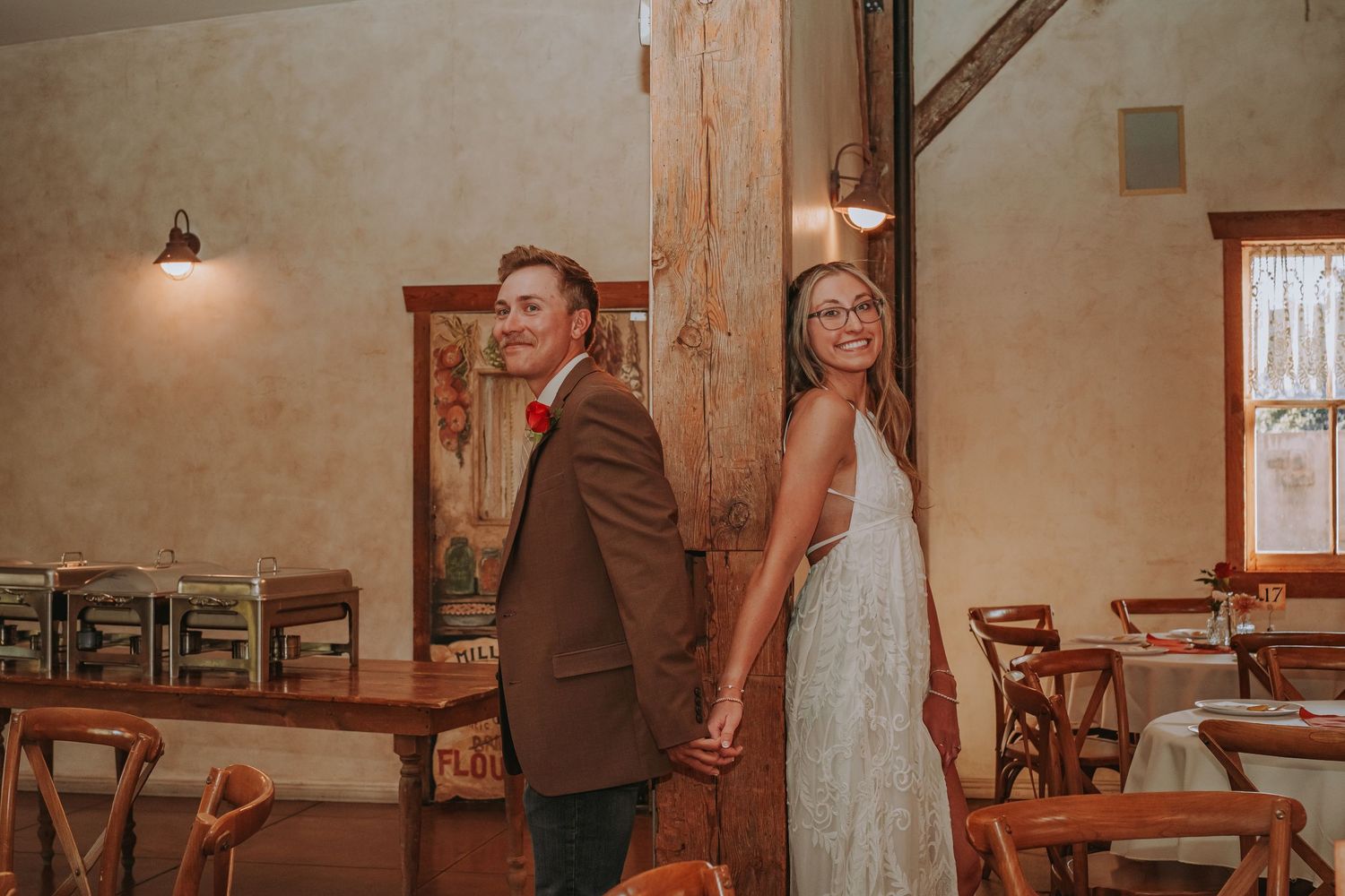 Wedding celebration in a rustic indoor venue with warm lighting.