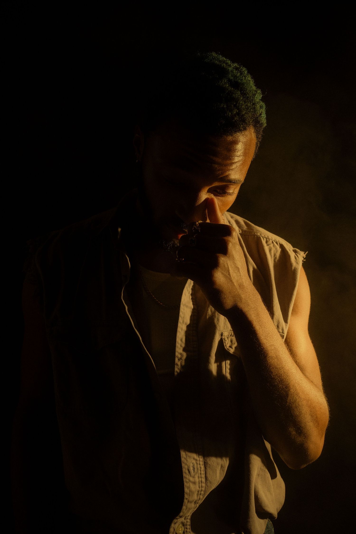 Dramatic portrait series in dark lighting showing emotional expressions.