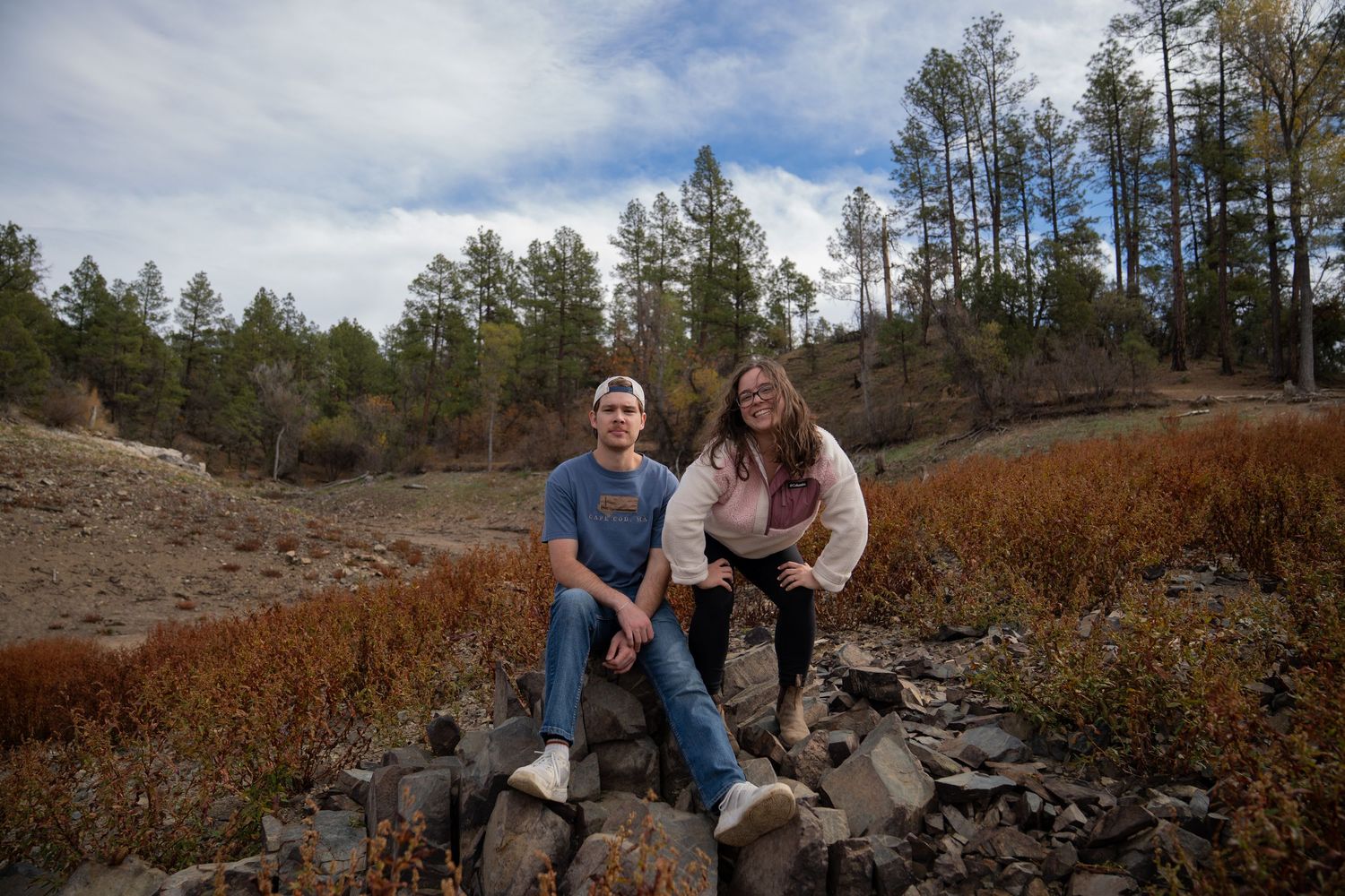 Romantic outdoor photo session with mountain landscape and fall colors in background.