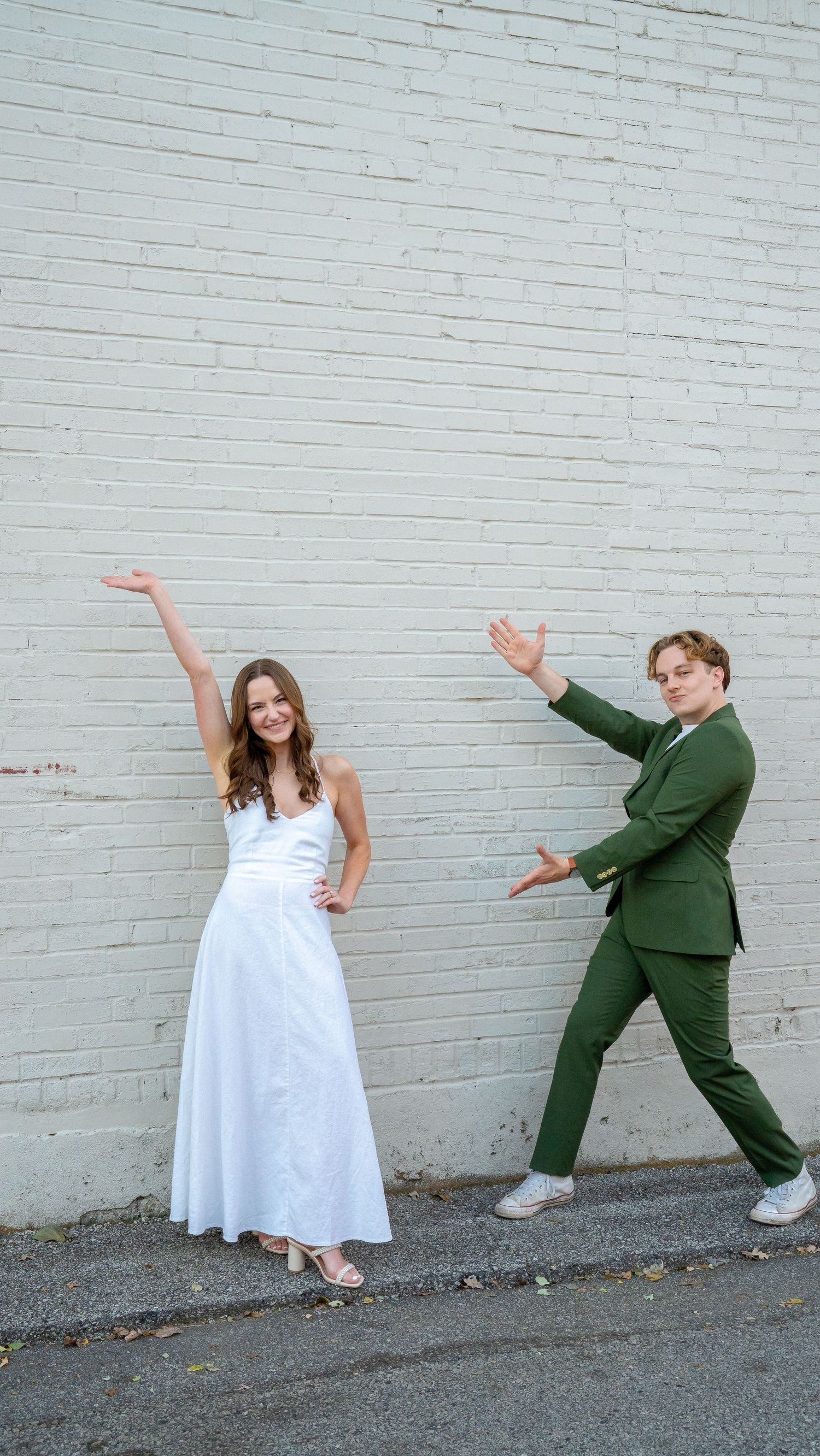 Fun photo sequence shows couple in white dress and green suit doing dramatic poses by brick wall.