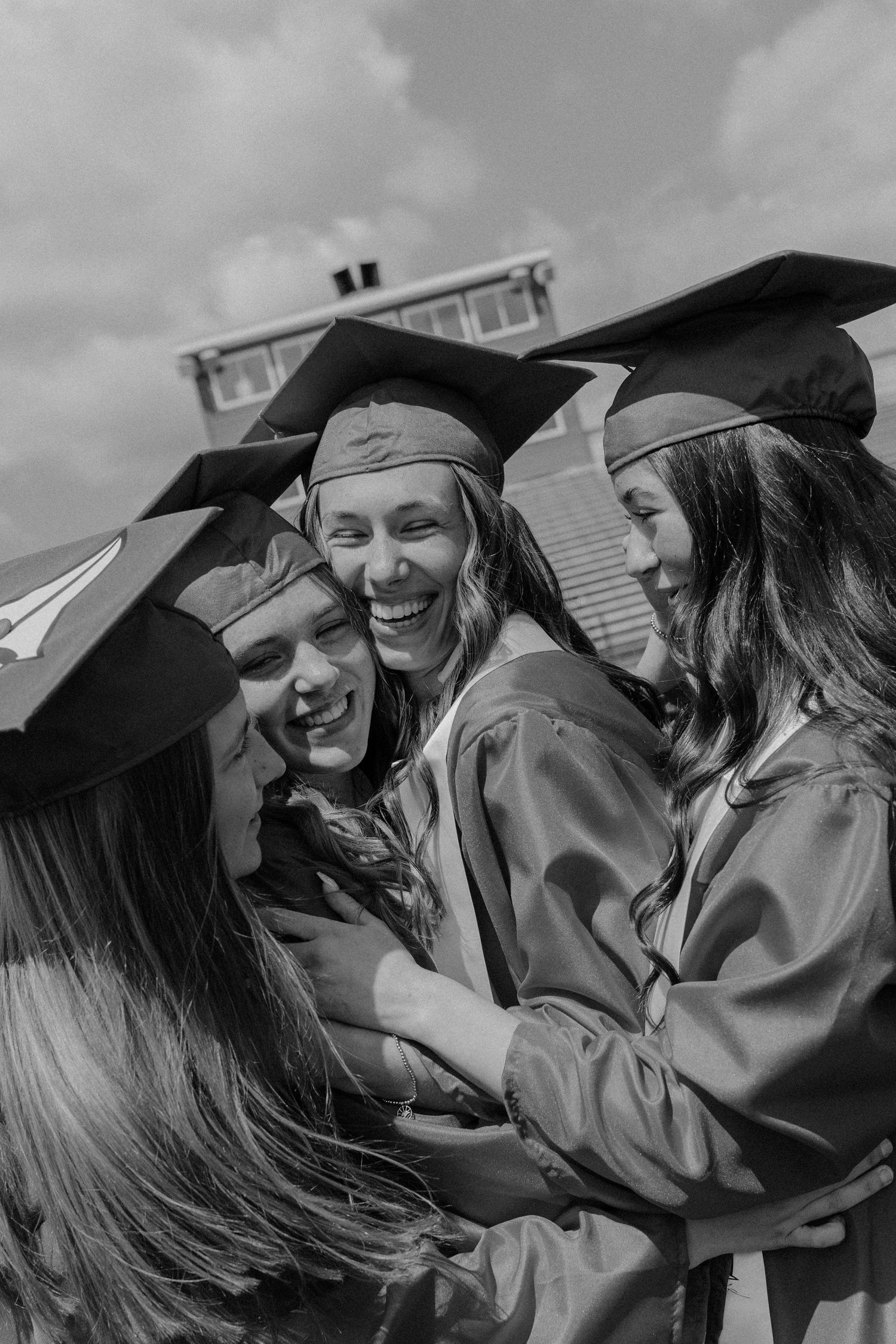 Black and white photo of senior hugging  — Segura Shots cap and gown photography detroit lakes, MN