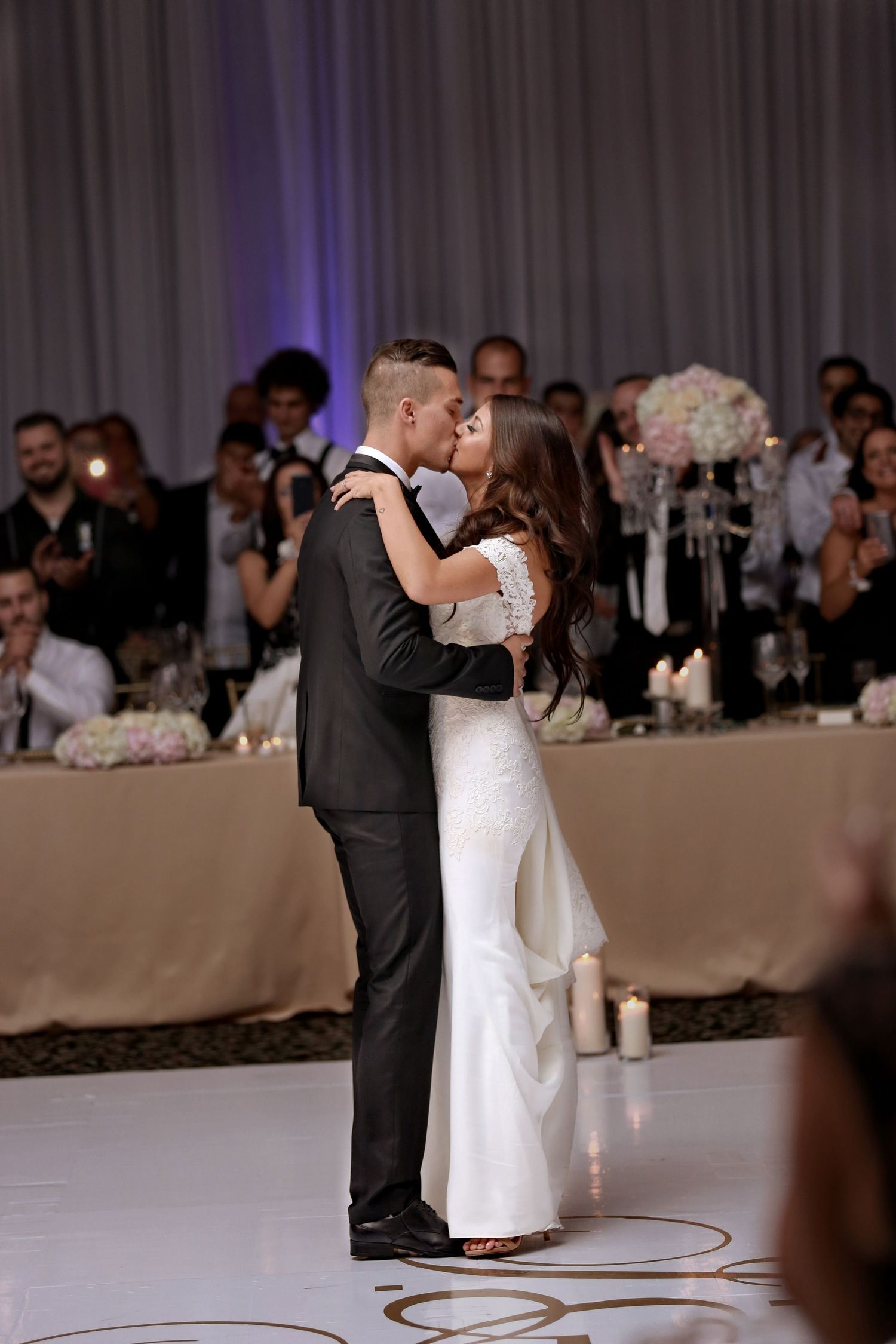 Bride and groom's first dance at wedding reception, candid wedding photography