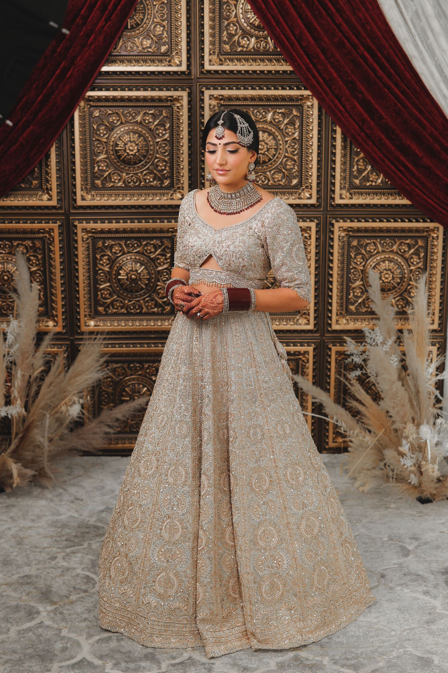 Bride in cream and gold lehenga during bridal morning portraits