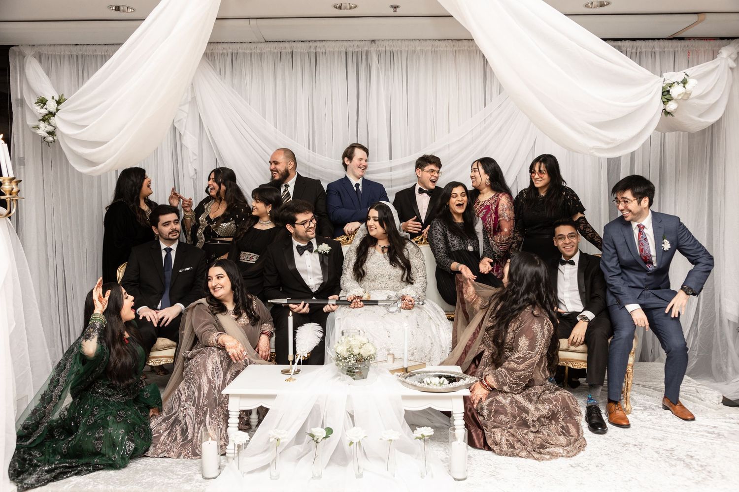 Bride, groom and wedding party group portrait at Nikah reception