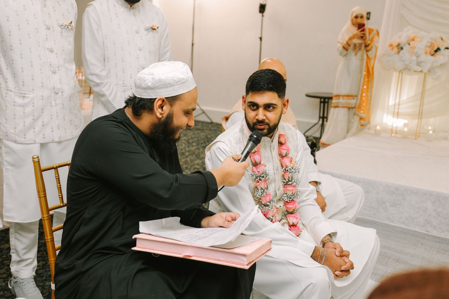 Groom saying Qabool Qabool at Nikah with officiant, Muslim wedding ceremony