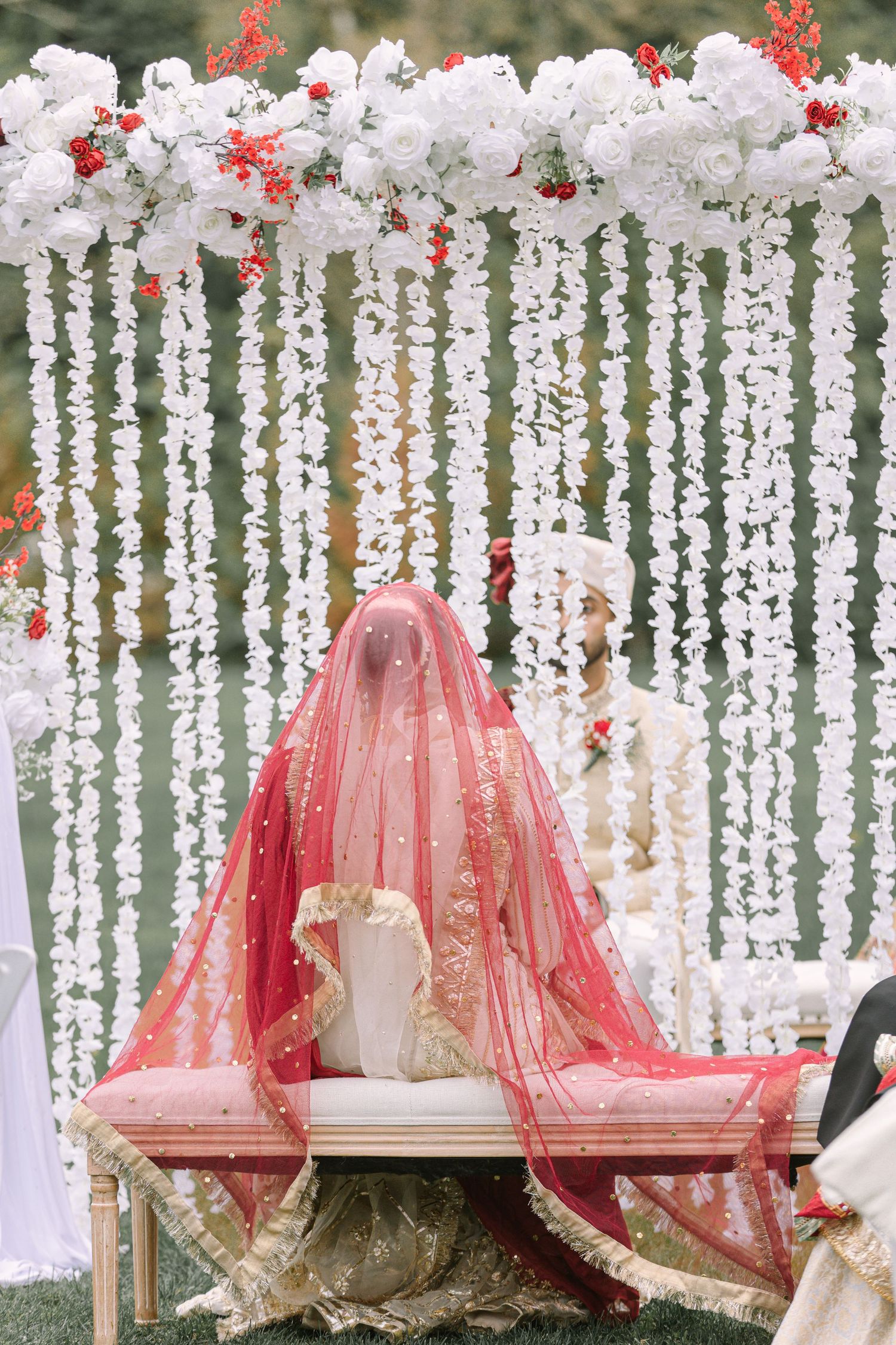 Decorated ceremony swing with pink florals, wedding mandap setup