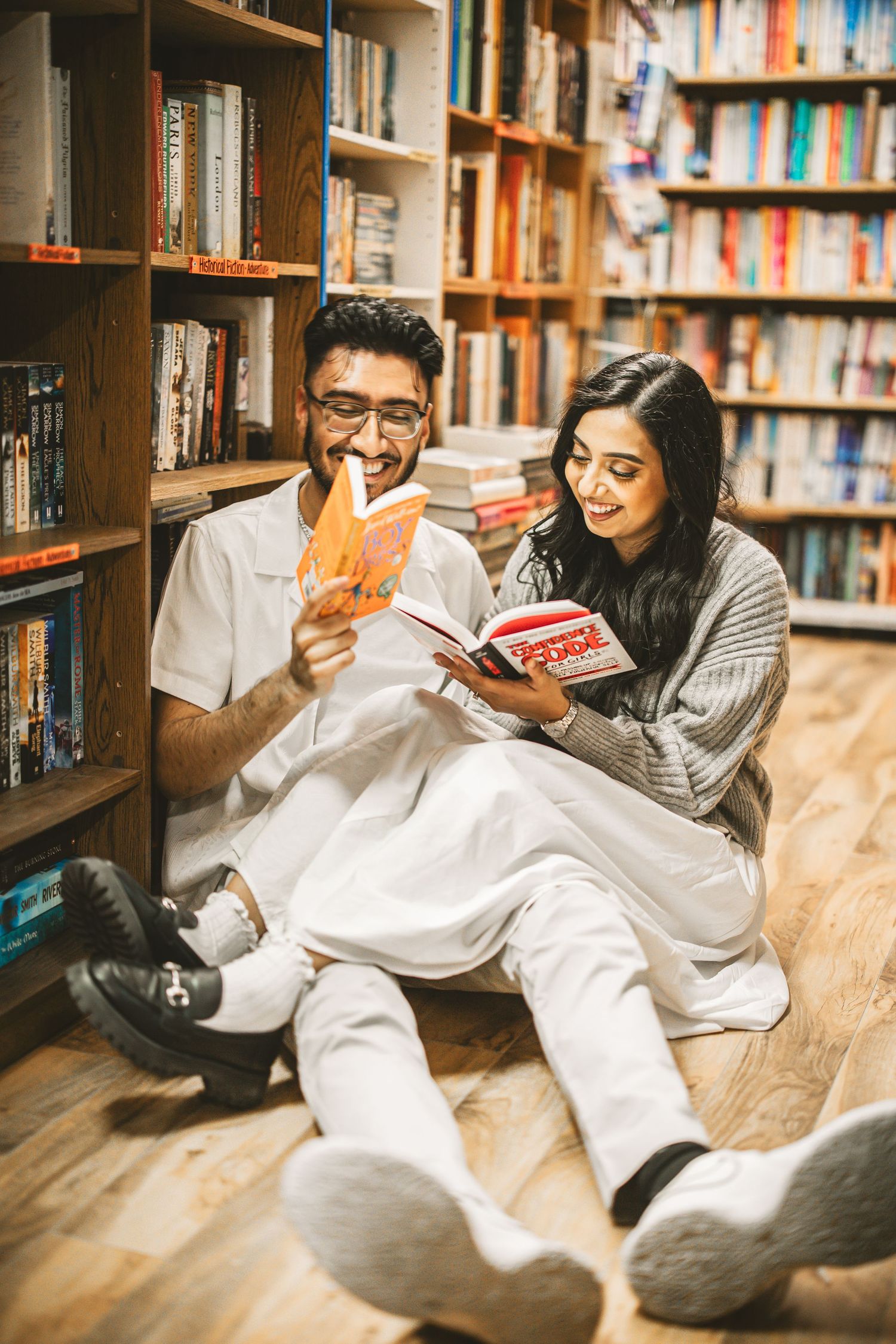 Couple reading together in library during engagement photoshoot, Vancouver