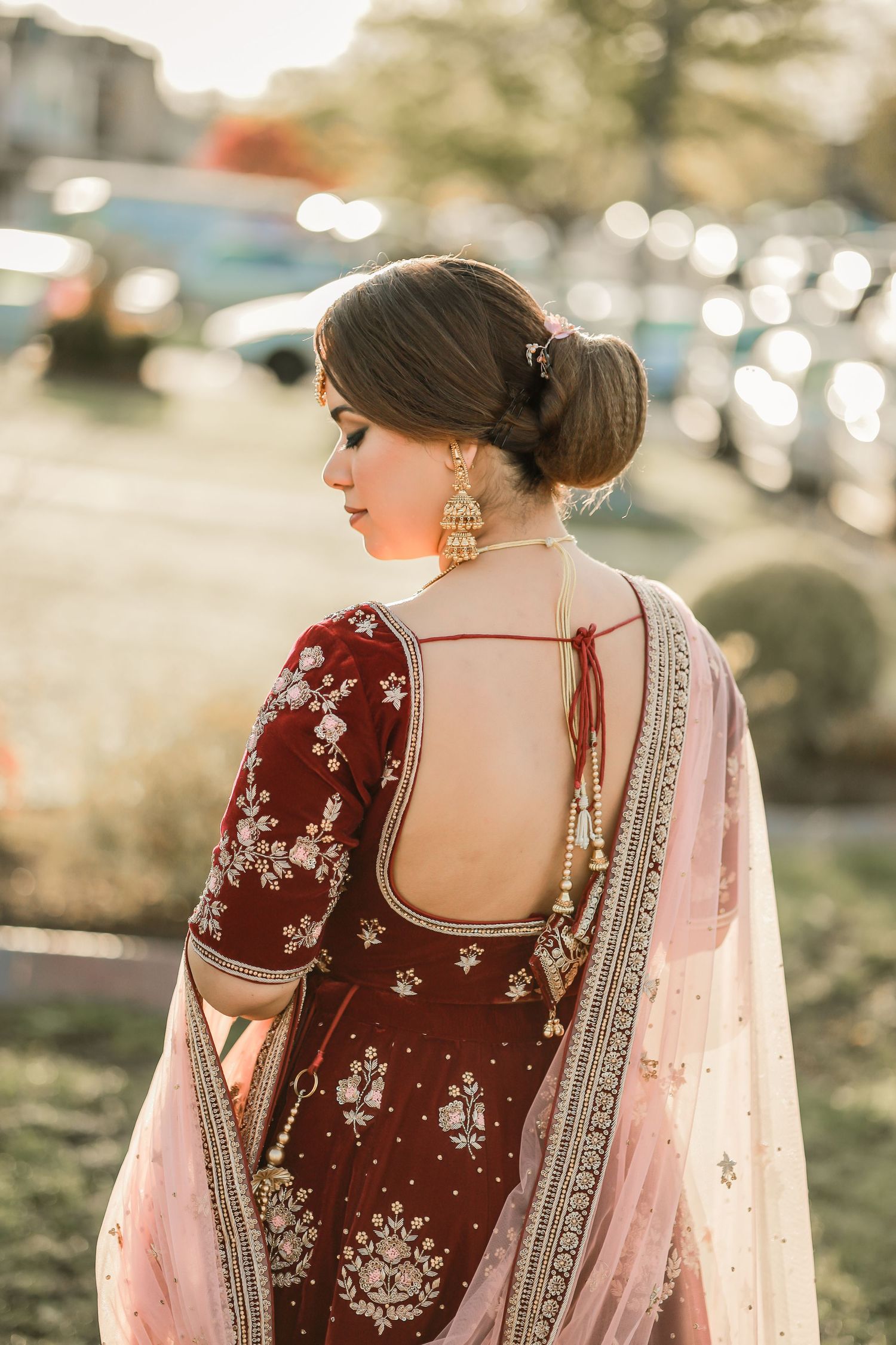 Bride in maroon embroidered lehenga outdoors, Vancouver wedding photographer