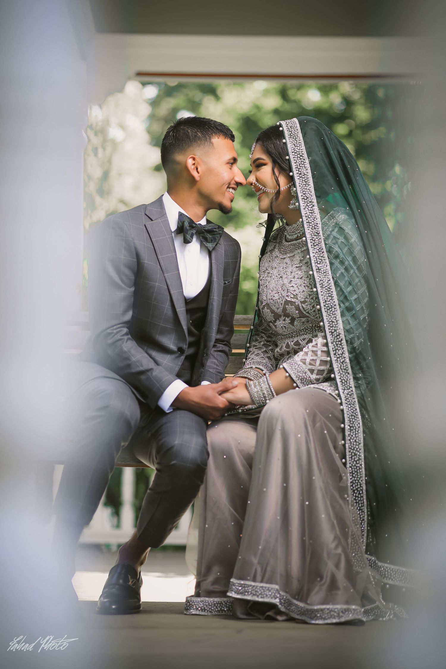 Bride and groom seated together at reception, elegant couple portrait