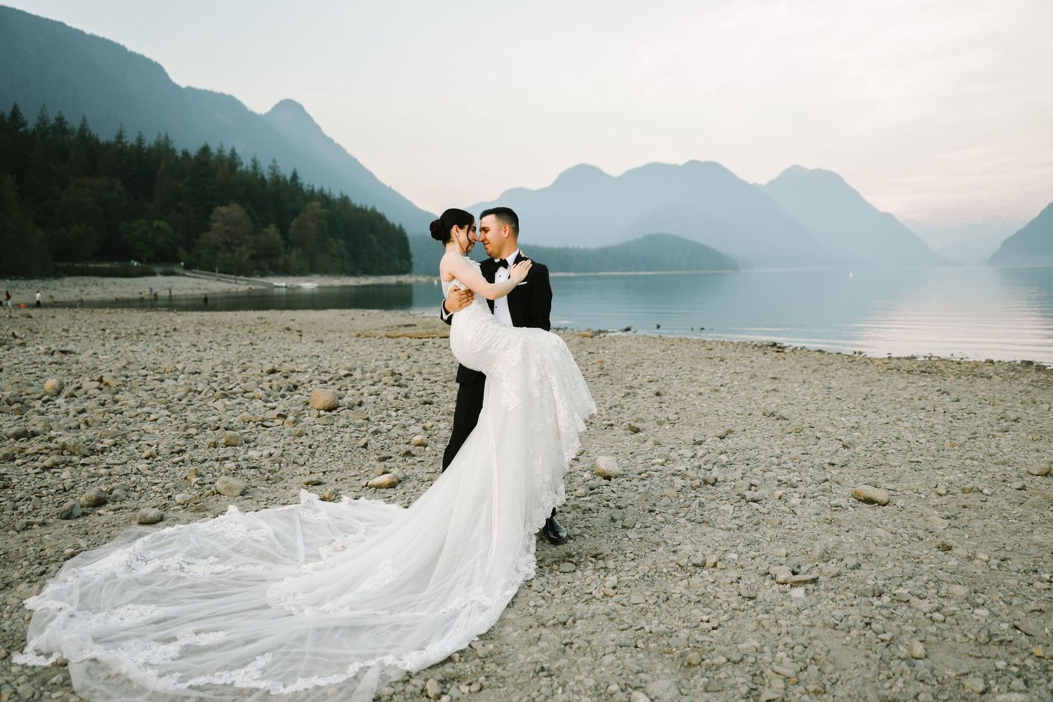 Couple embracing during pre-wedding photoshoot with mountain backdrop