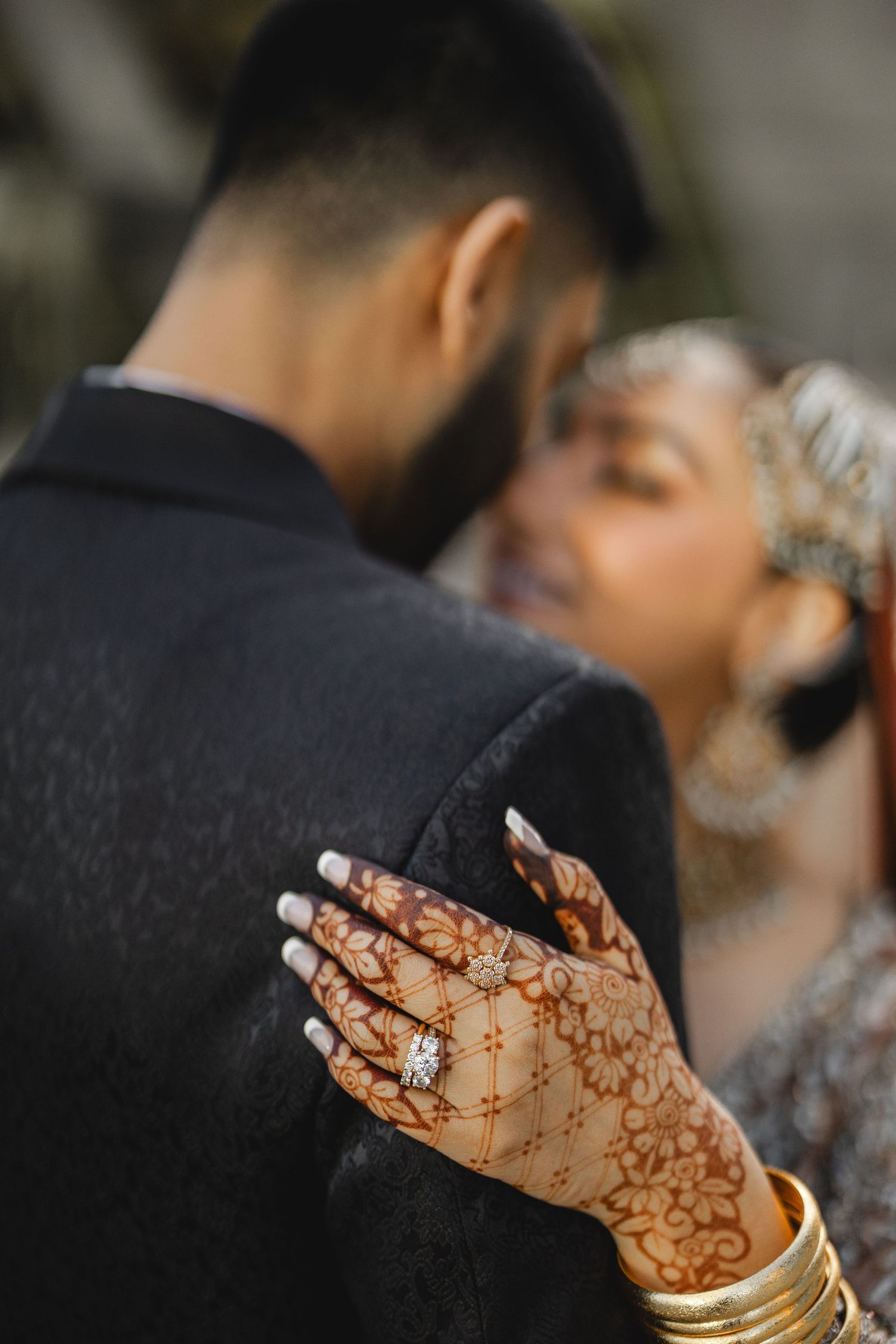 Groom and bride sharing intimate moment, henna mehndi detail at pre reception photoshoot