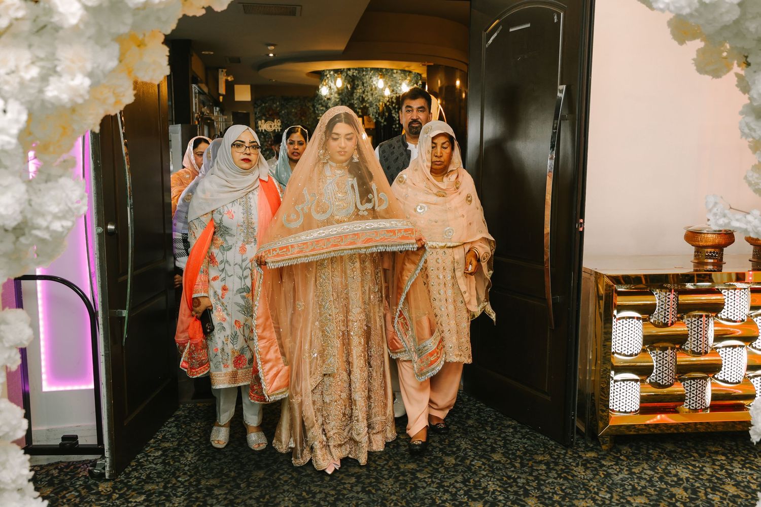 Bride entering ceremony room with family, Muslim wedding at taste of lahore event center.