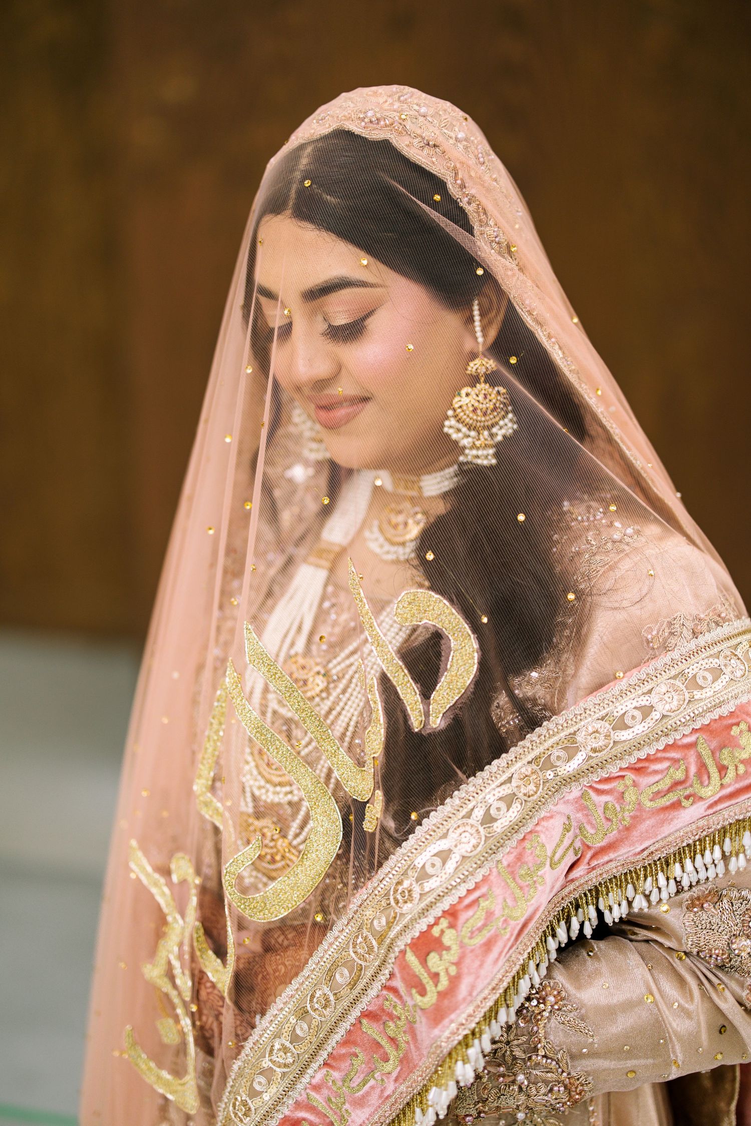 Muslim bride in traditional dress with bridal veil