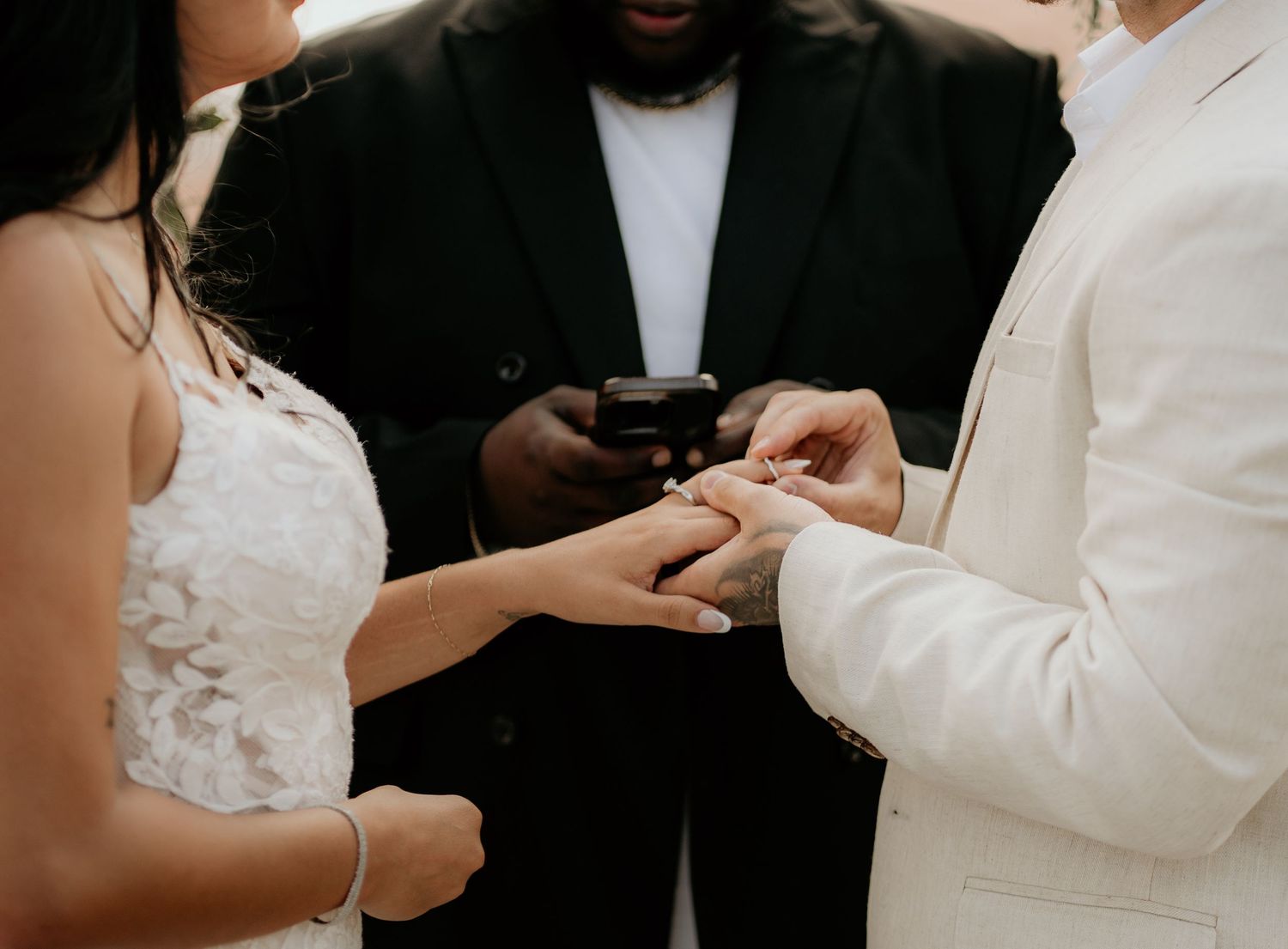 Close-up of wedding ring exchange during ceremony.