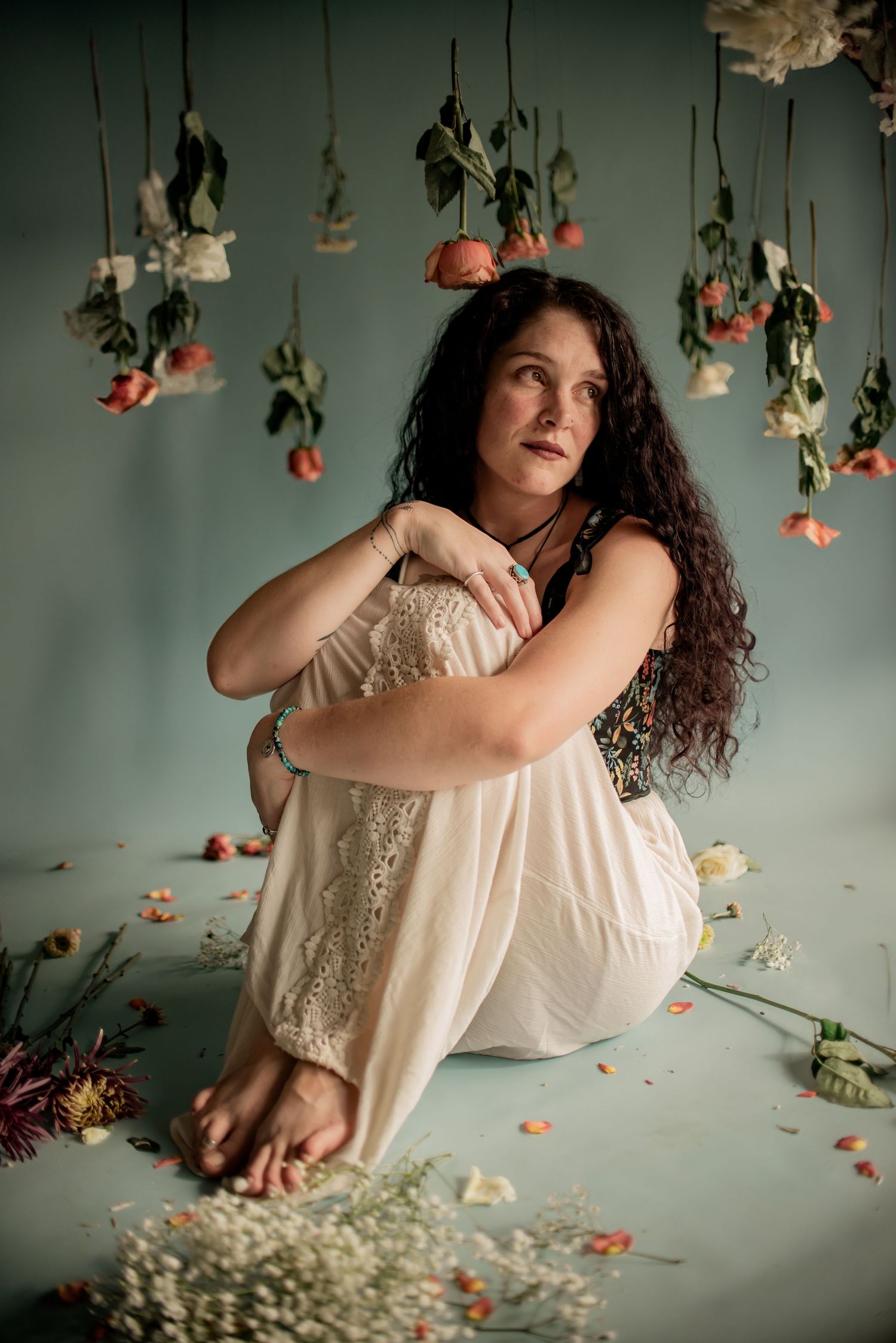Ethereal indoor photo with suspended floral arrangements and soft lighting.