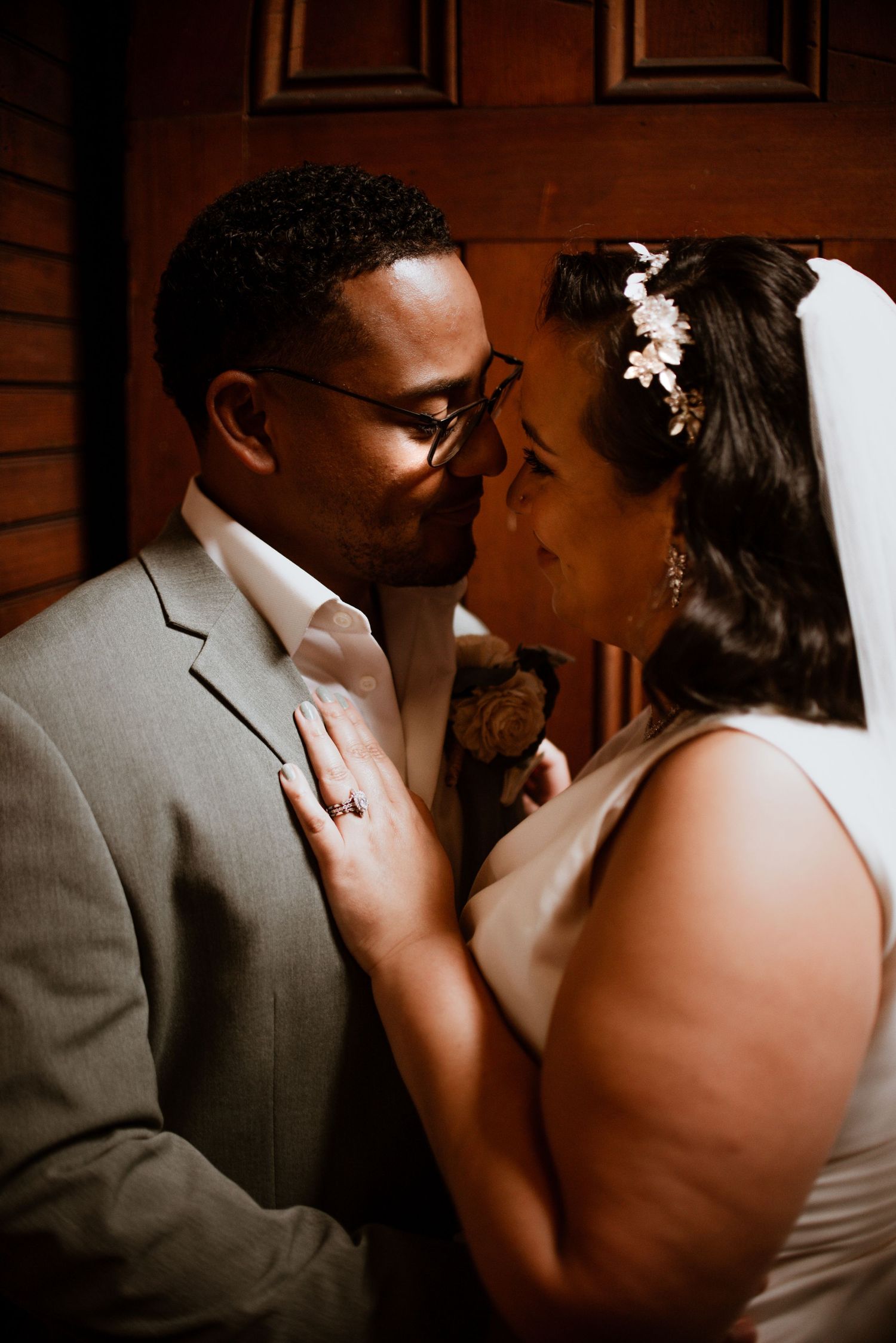 Intimate wedding portrait showing tender moment between newlyweds.