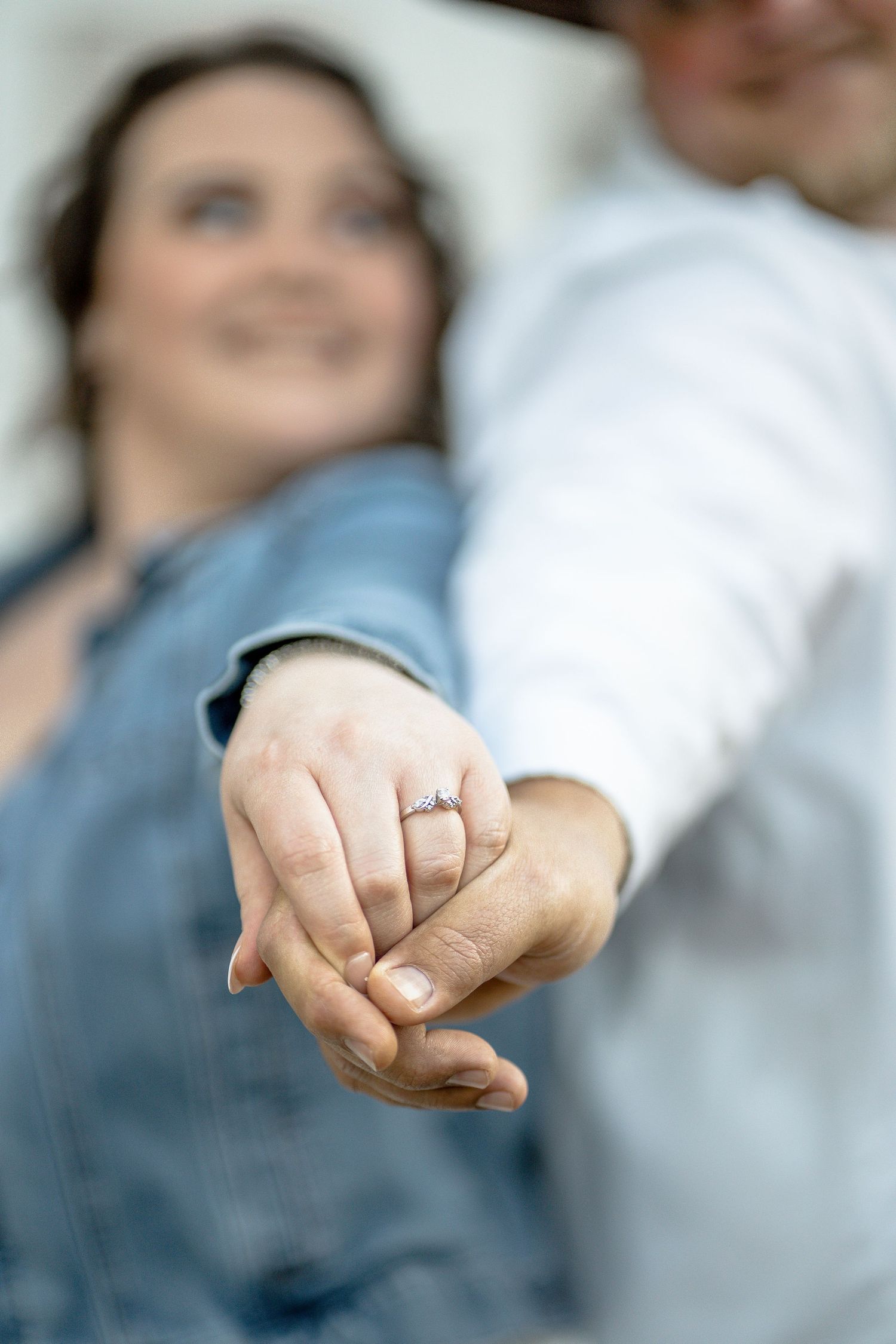 Close-up sequence of hands displaying engagement ring against soft background.