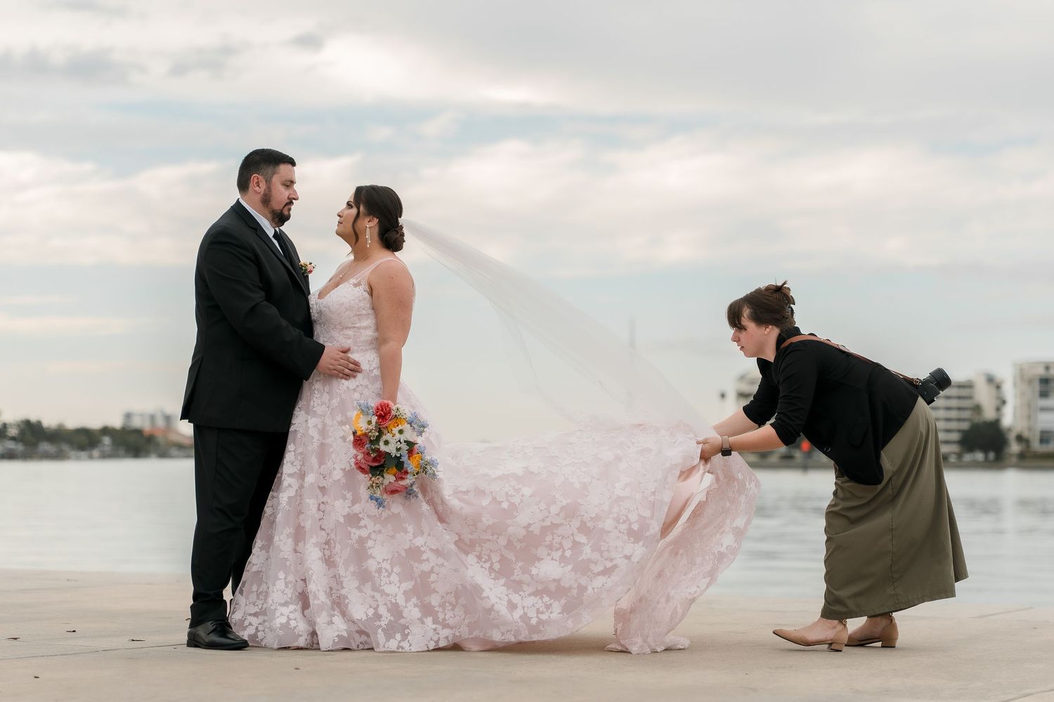 Beach wedding photography session at sunset with flowing dress.